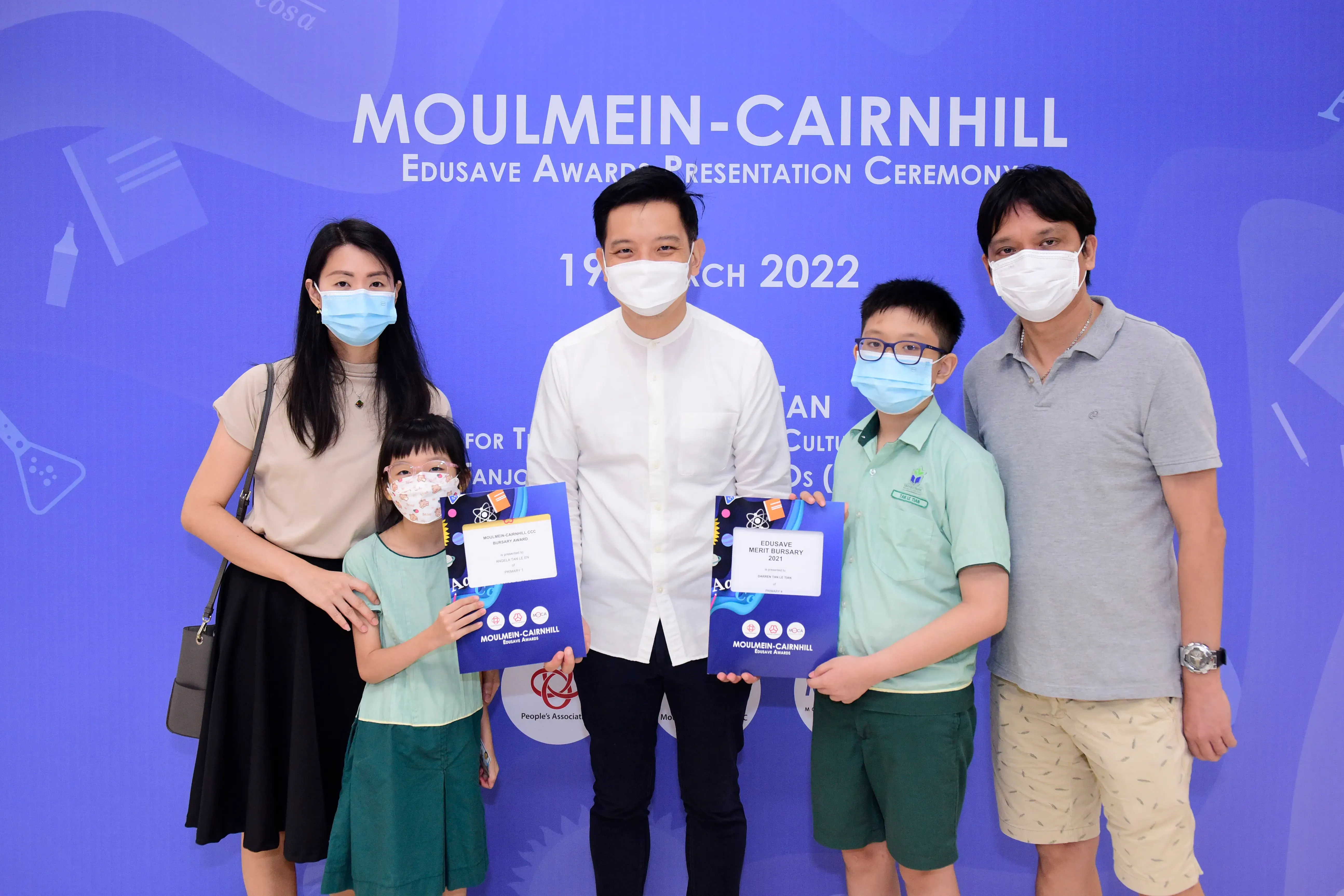 Five masked people pose at the Moulmein-Cairnhill Edusave Awards Presentation Ceremony on 19 March 2022.