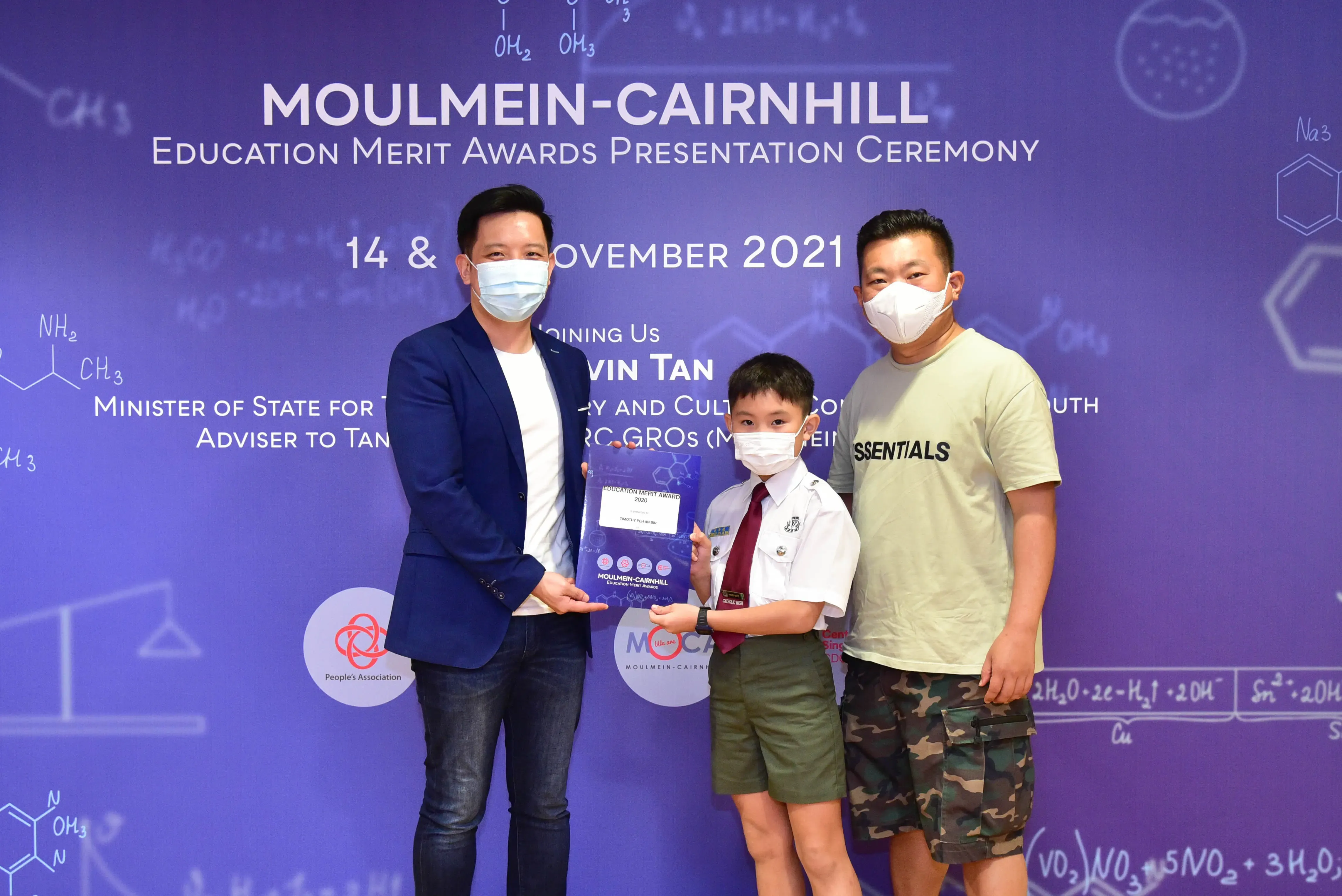 Three masked individuals pose at the Moulmein-Cairnhill Education Merit Awards Ceremony in November 2021.