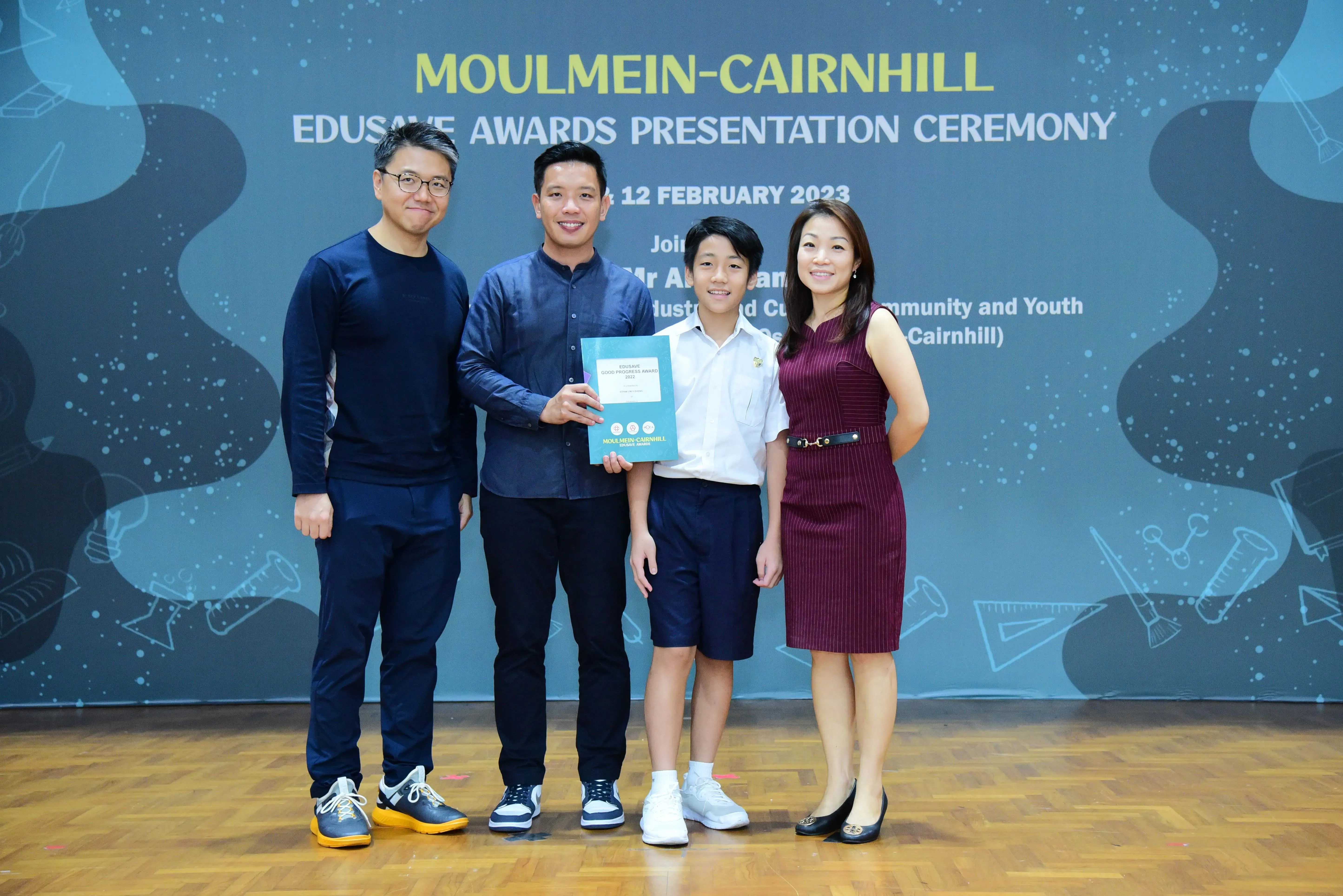 Four people pose with an award certificate at the Moulmein-Cairnhill Edusave Awards Presentation Ceremony on 12 February 2023.