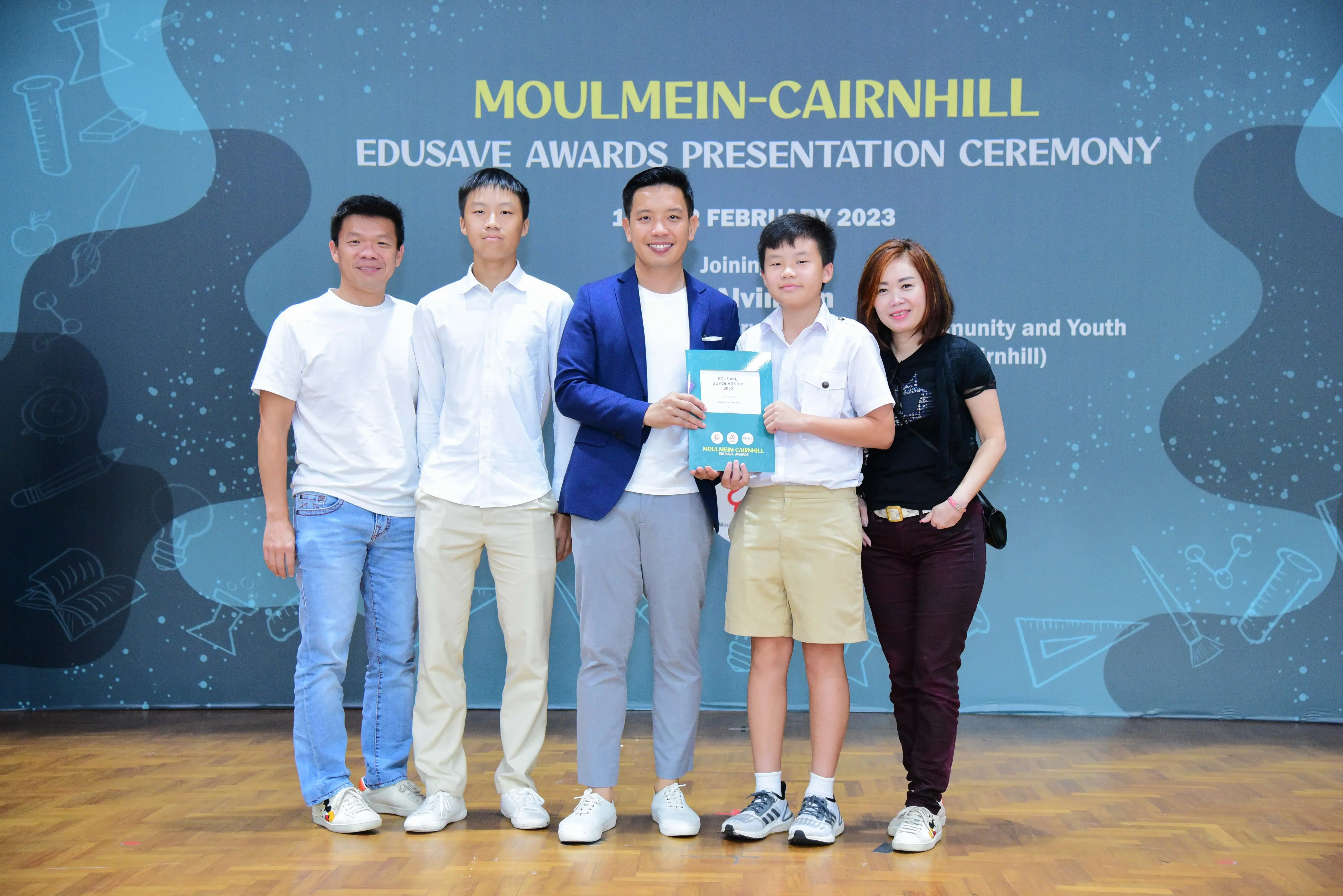Five people pose at the Moulmein-Cairnhill Edusave Awards Presentation Ceremony in February 2023.