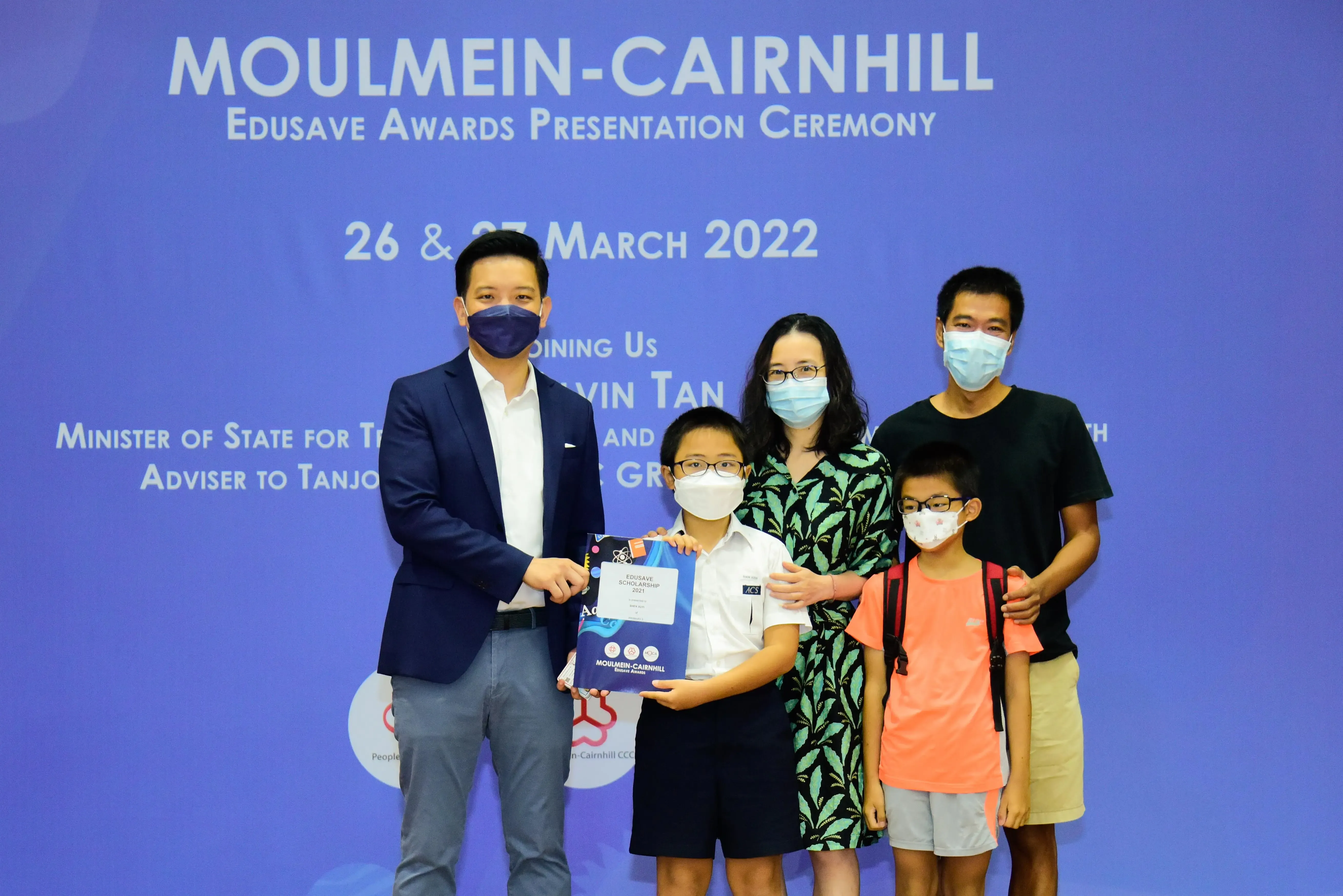 Five masked people pose at the Moulmein-Cairnhill Edusave Awards Presentation Ceremony on 26 March 2022.