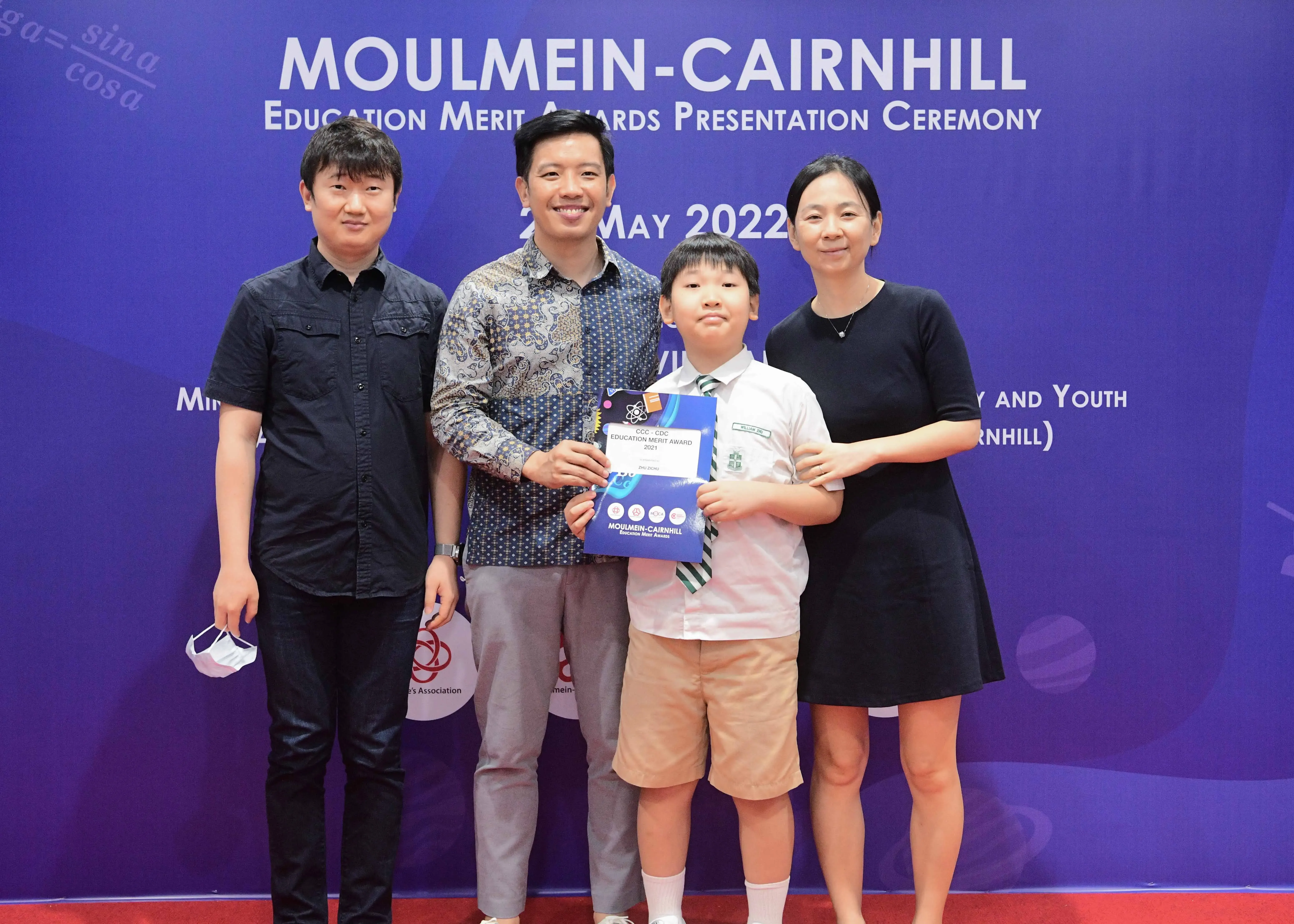 Four people pose at the Moulmein-Cairnhill Education Merit Awards Presentation Ceremony on May 2022.