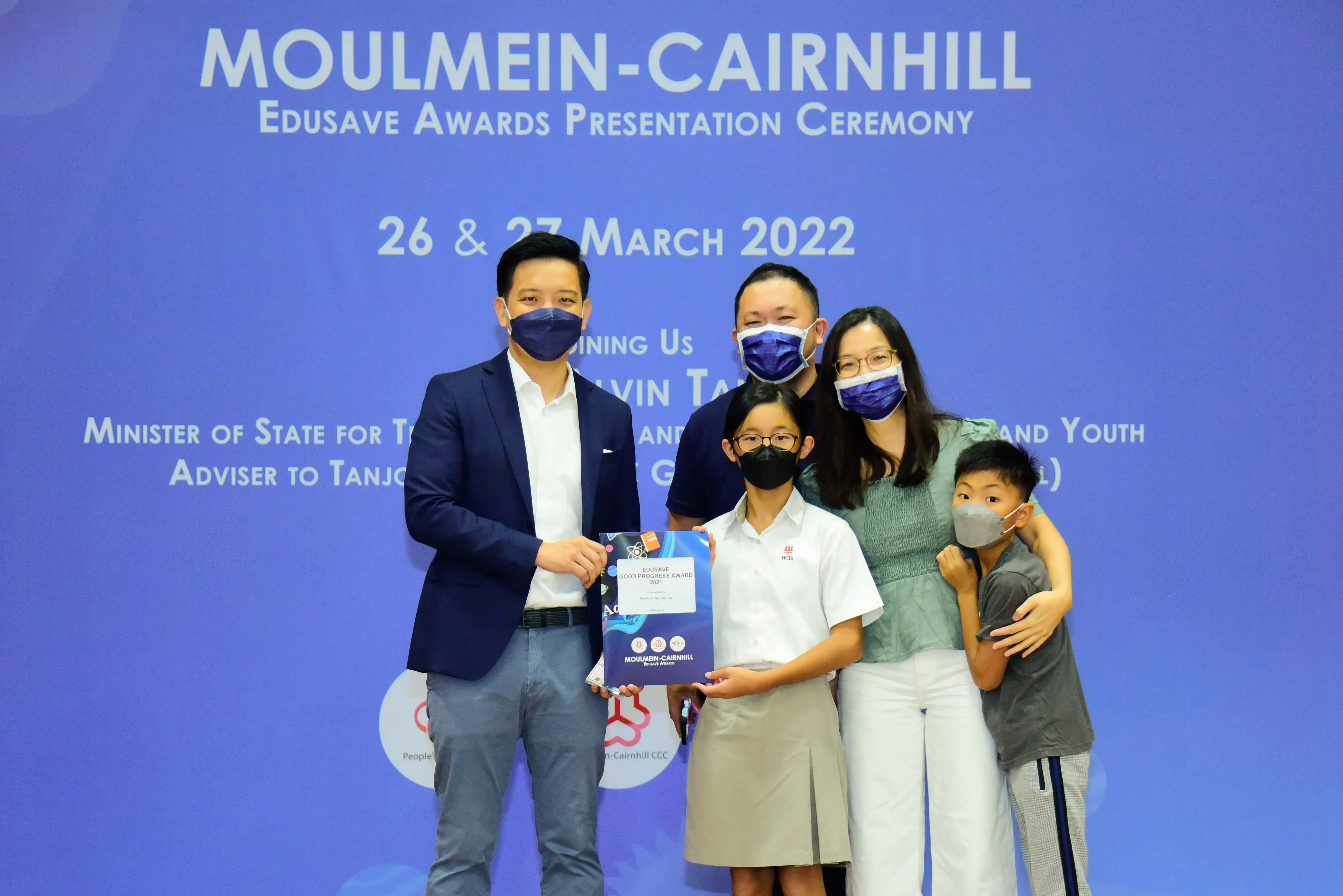 Five masked people pose at the Moulmein-Cairnhill Edusave Awards Presentation Ceremony on 26-27 March 2022.