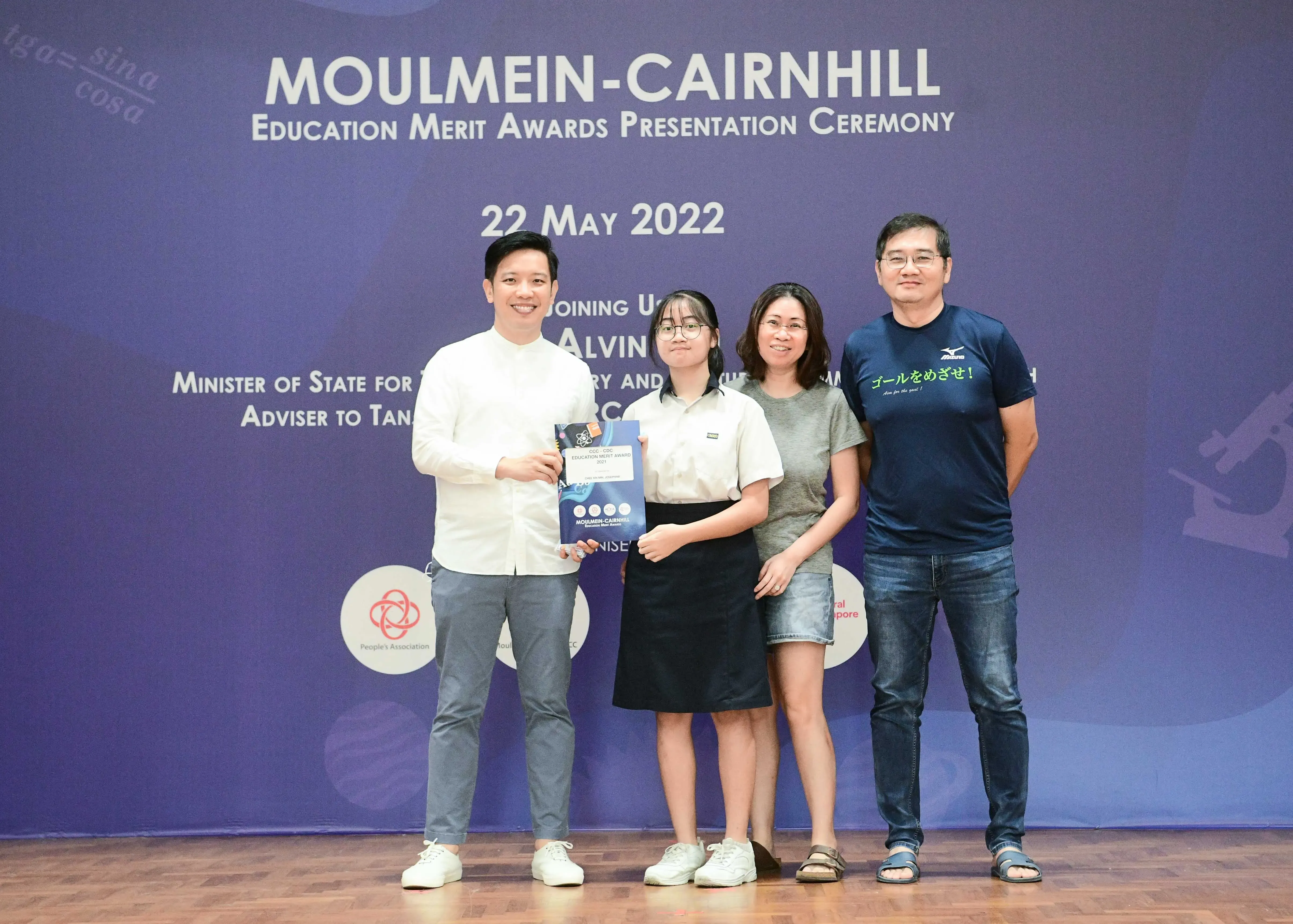 Four people pose together at the Moulmein-Cairnhill Education Merit Awards Ceremony on 22 May 2022.