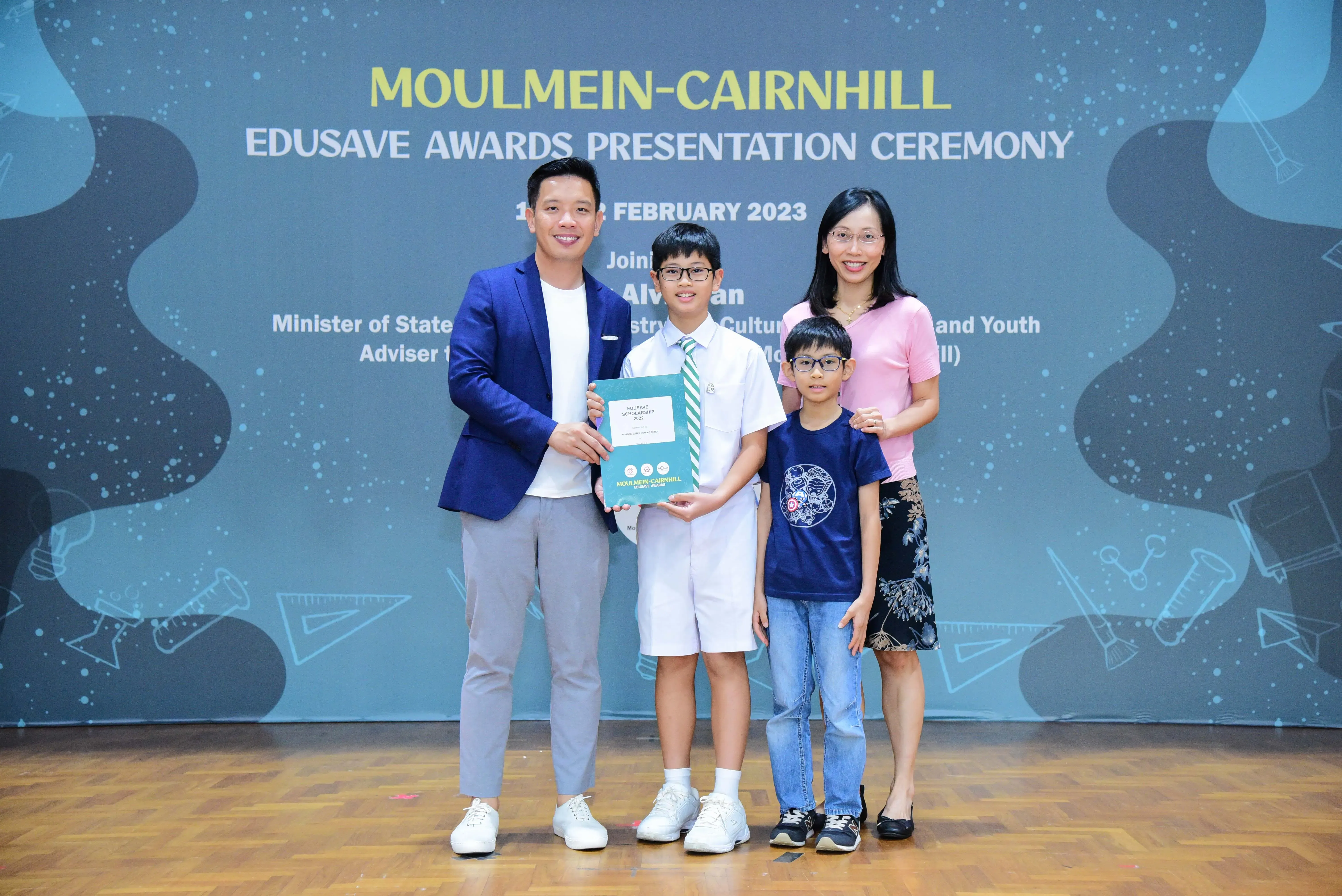 Four people pose together at the Moulmein-Cairnhill Edusave Awards Presentation Ceremony in February 2023.
