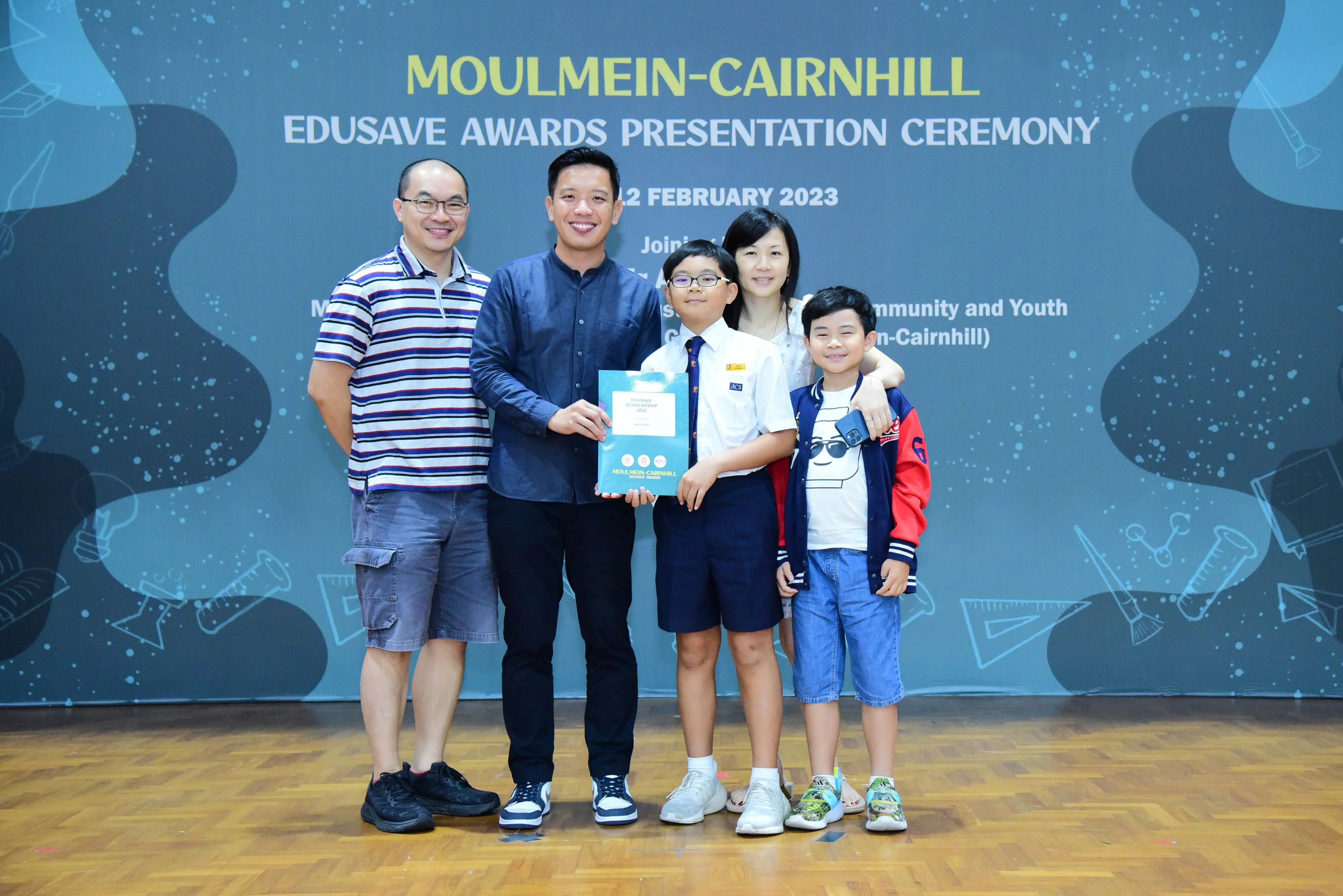Five people pose at the Moulmein-Cairnhill Edusave Awards Presentation Ceremony on 12 February 2023.