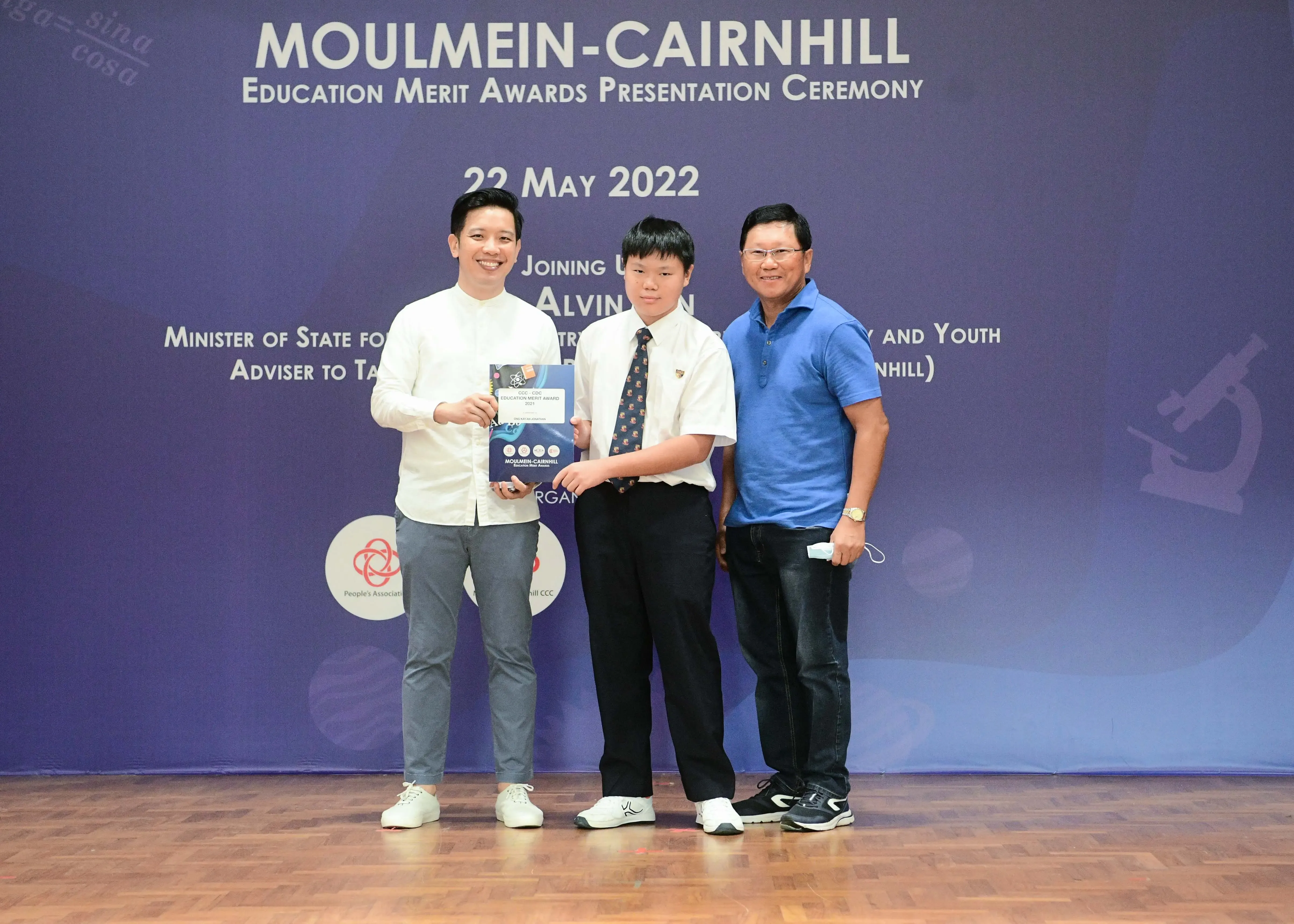 Three people pose at the Moulmein-Cairnhill Education Merit Awards Presentation Ceremony on 22 May 2022.