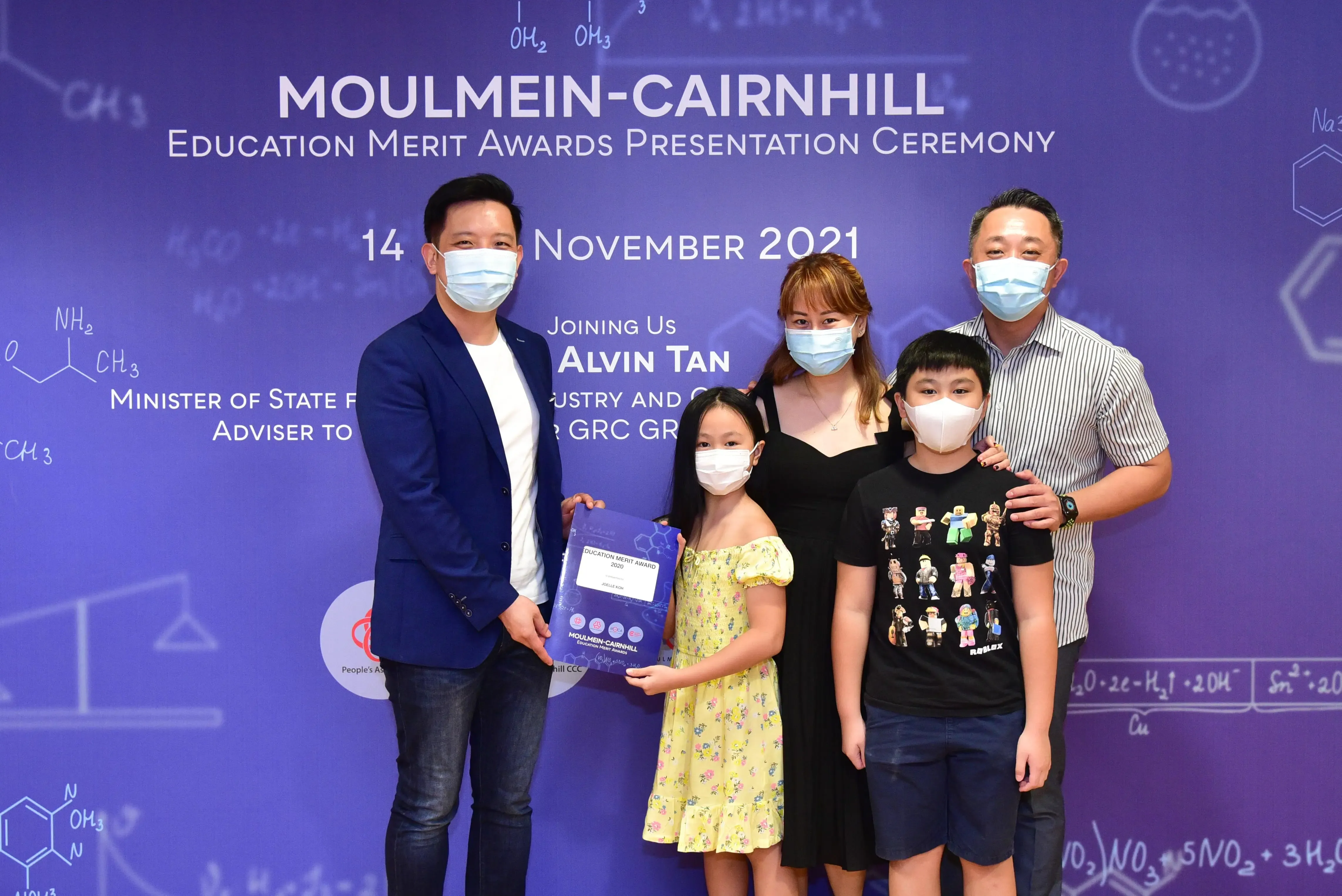 Five masked people pose at the Moulmein-Cairnhill Education Merit Awards Ceremony on 14 November 2021.