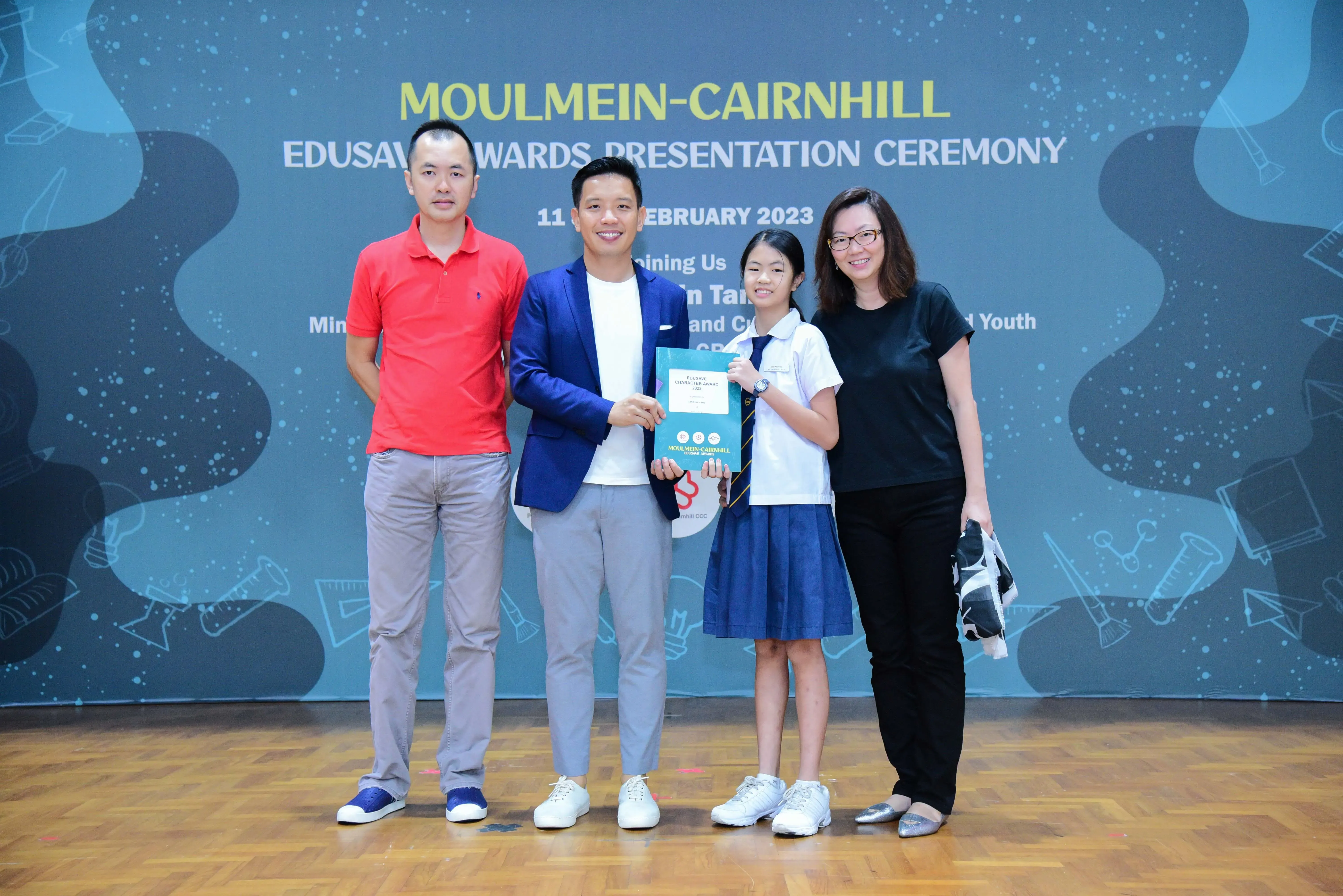 Four people pose at the Moulmein-Cairnhill Edusave Awards Presentation Ceremony on 11 February 2023.