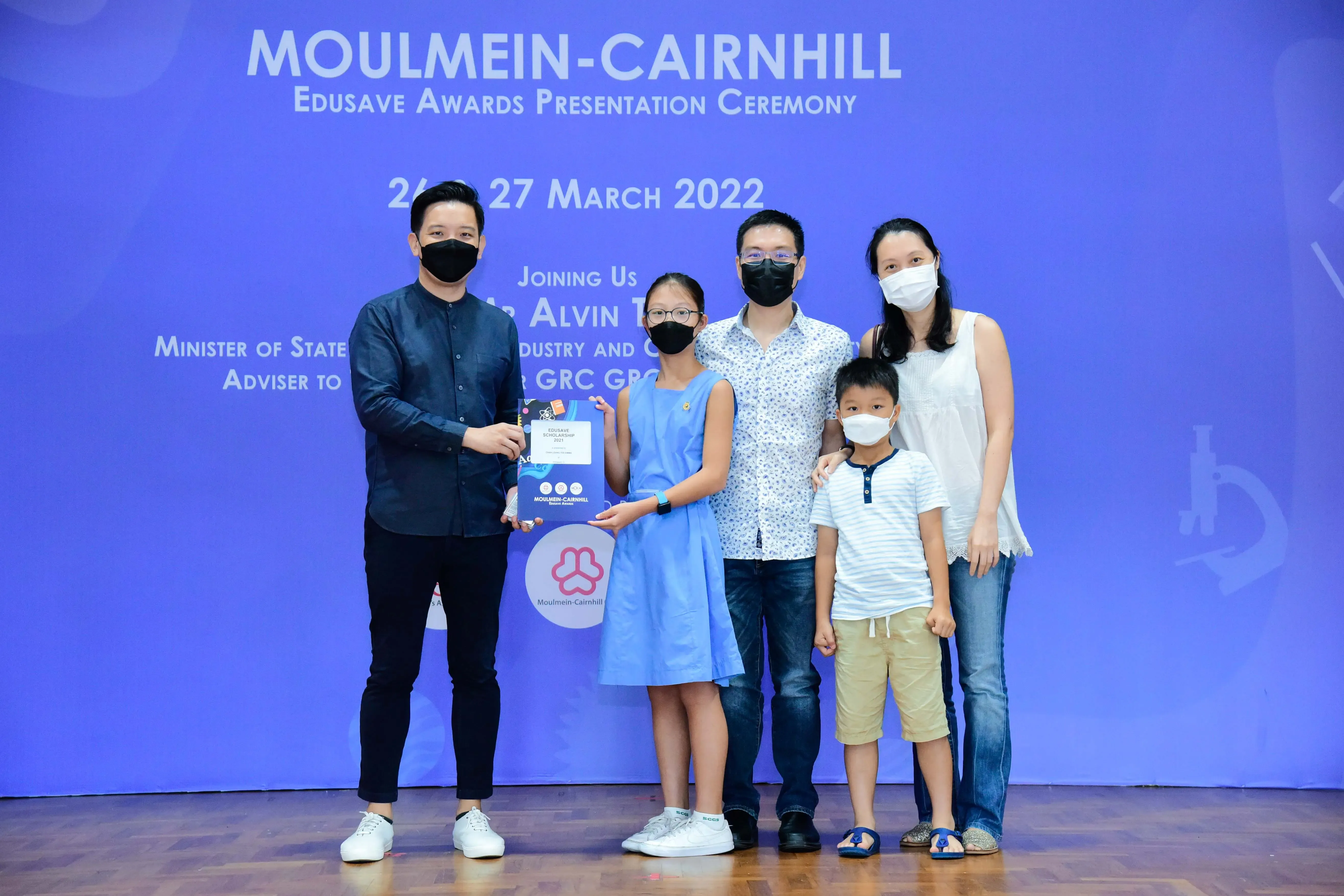 Five masked people pose at the Moulmein-Cairnhill Edusave Awards Ceremony on 26-27 March 2022.