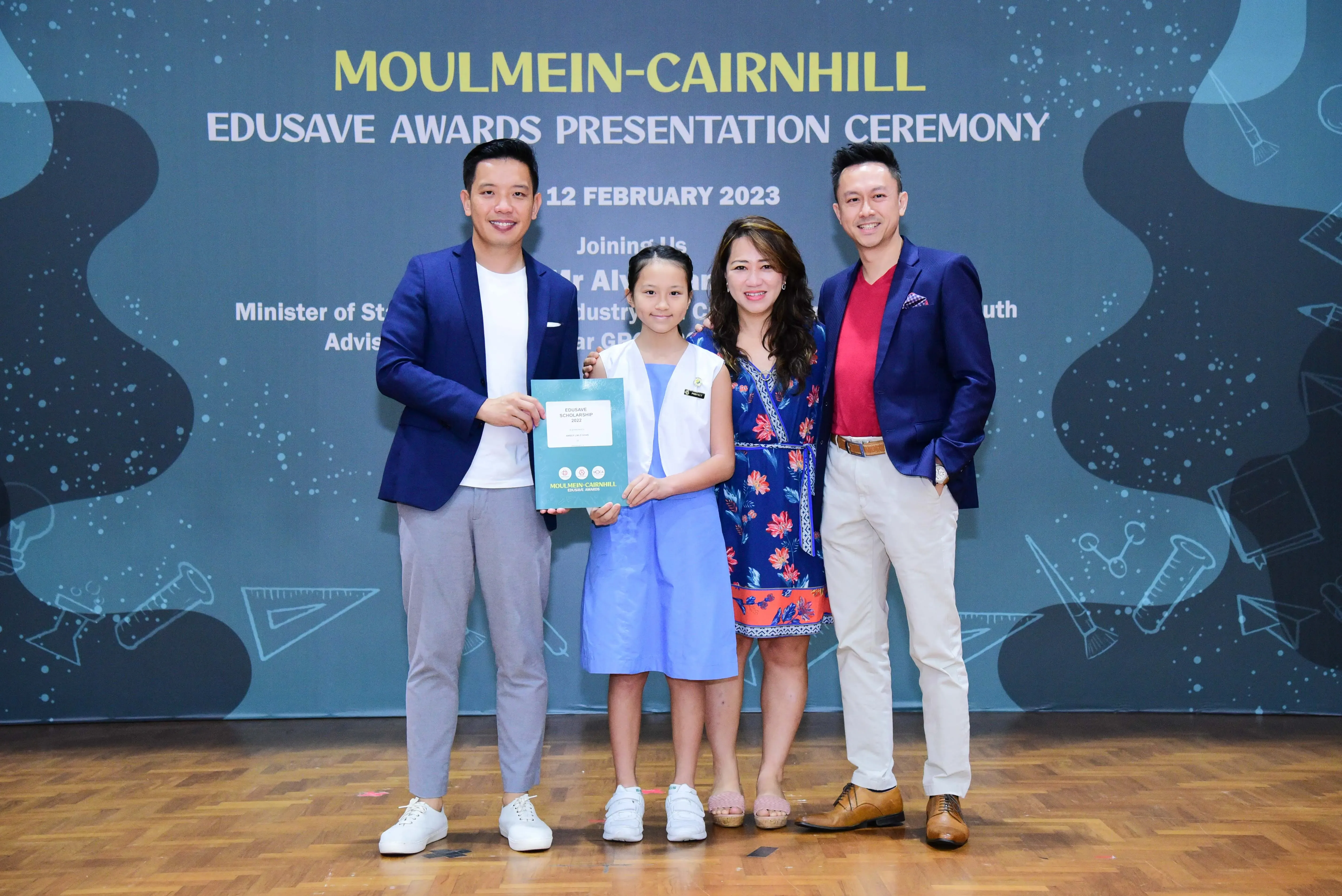 Four people pose with a certificate at the Moulmein-Cairnhill Edusave Awards Presentation Ceremony on 12 February 2023.