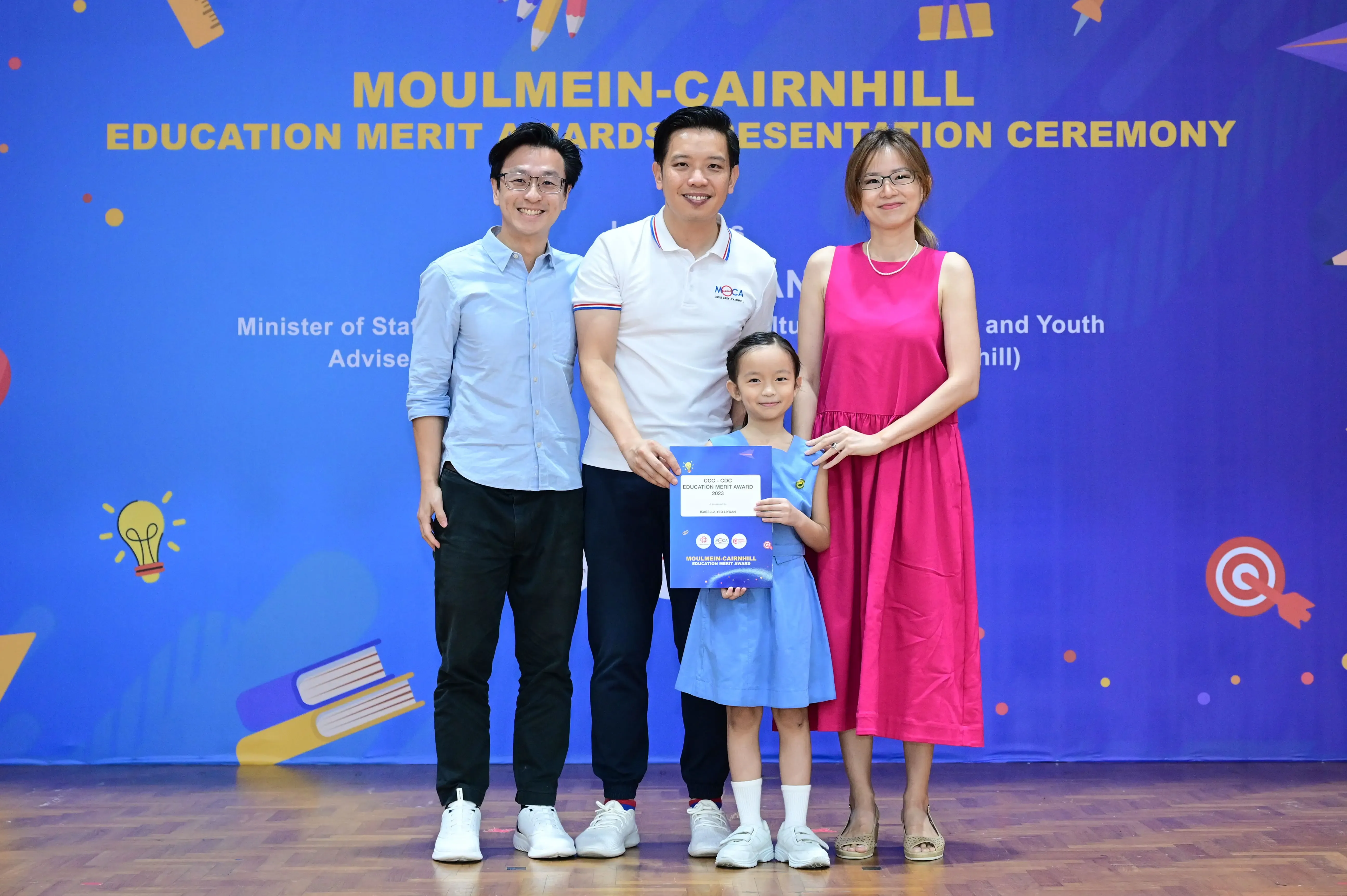 Three adults and a young girl pose at the Moulmein-Cairnhill Education Merit Awards Presentation Ceremony.