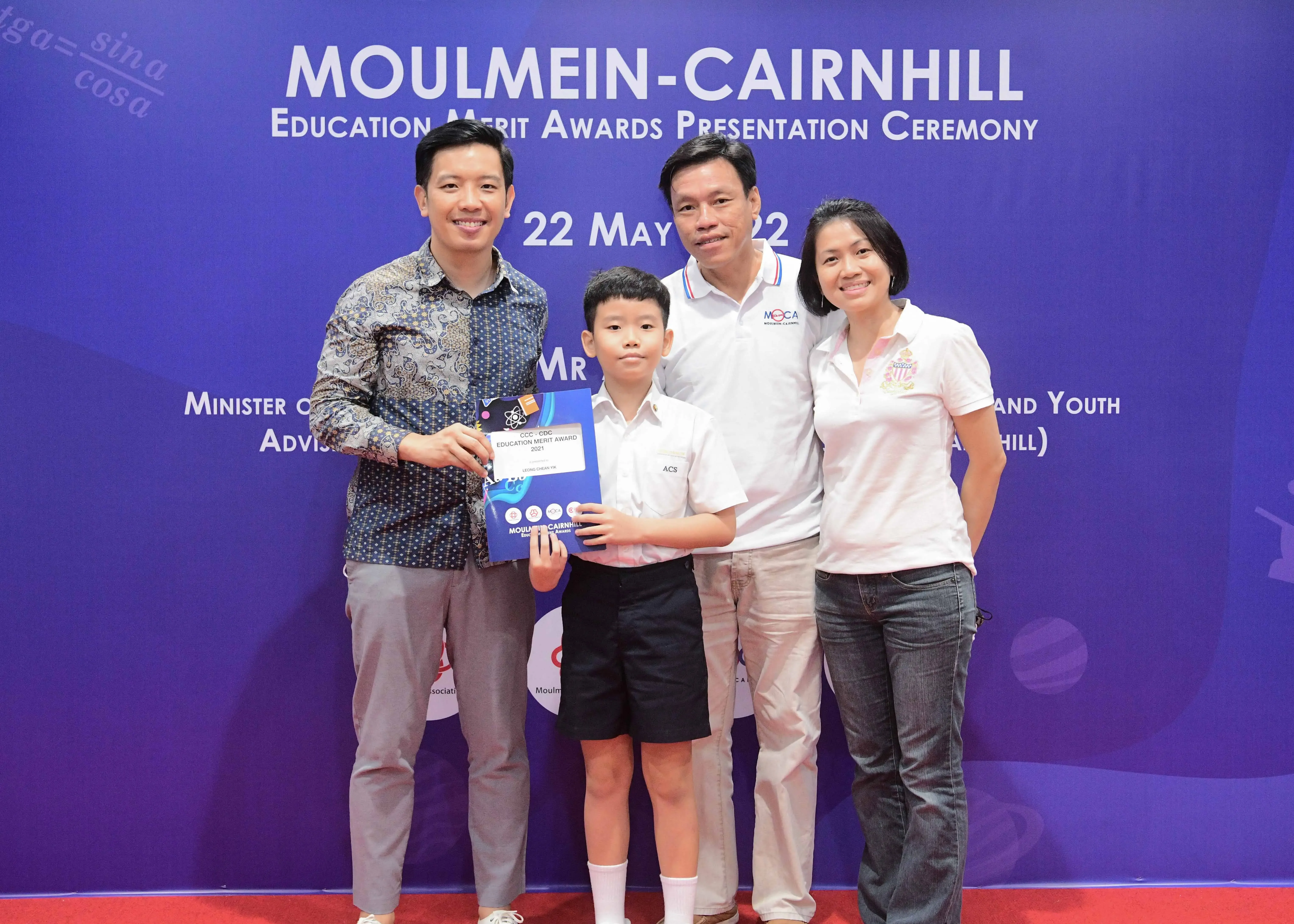 Four people pose at the Moulmein-Cairnhill Education Merit Awards Presentation Ceremony on 22 May 2022.