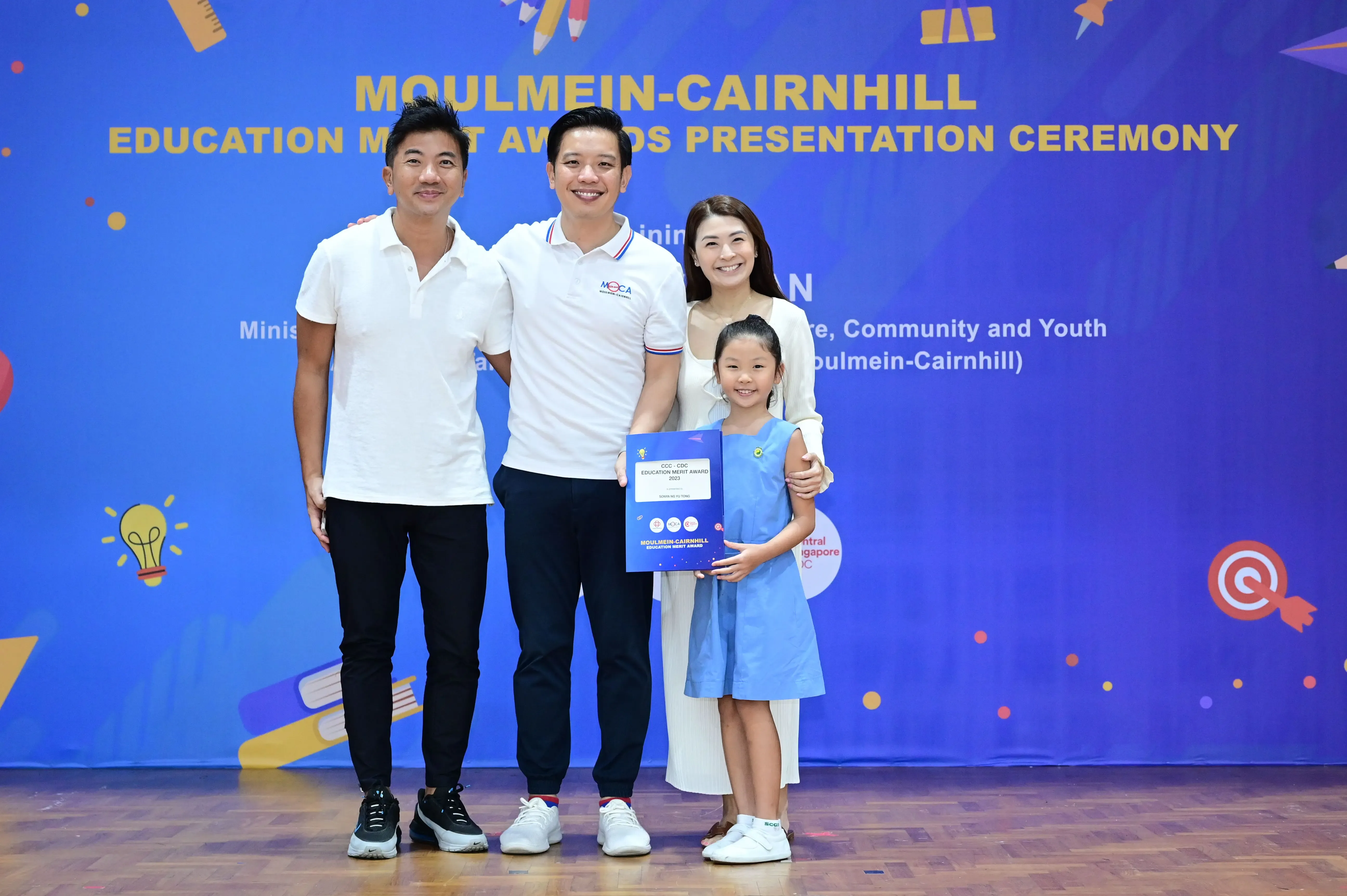 Three adults and a young girl pose at the Moulmein-Cairnhill Education Merit Awards Presentation Ceremony.
