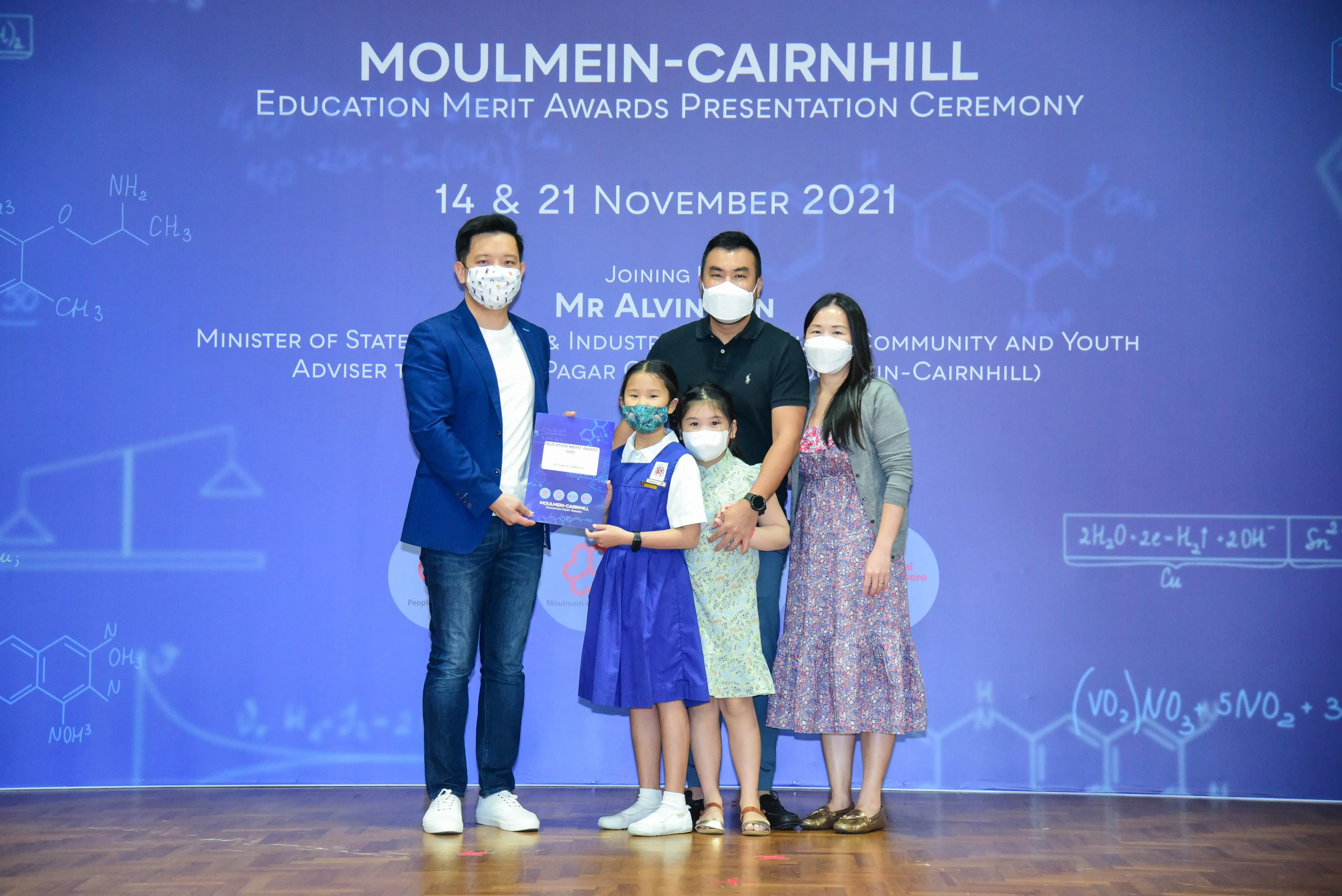 Five masked people pose at the Moulmein-Cairnhill Education Merit Awards Presentation Ceremony on November 2021.