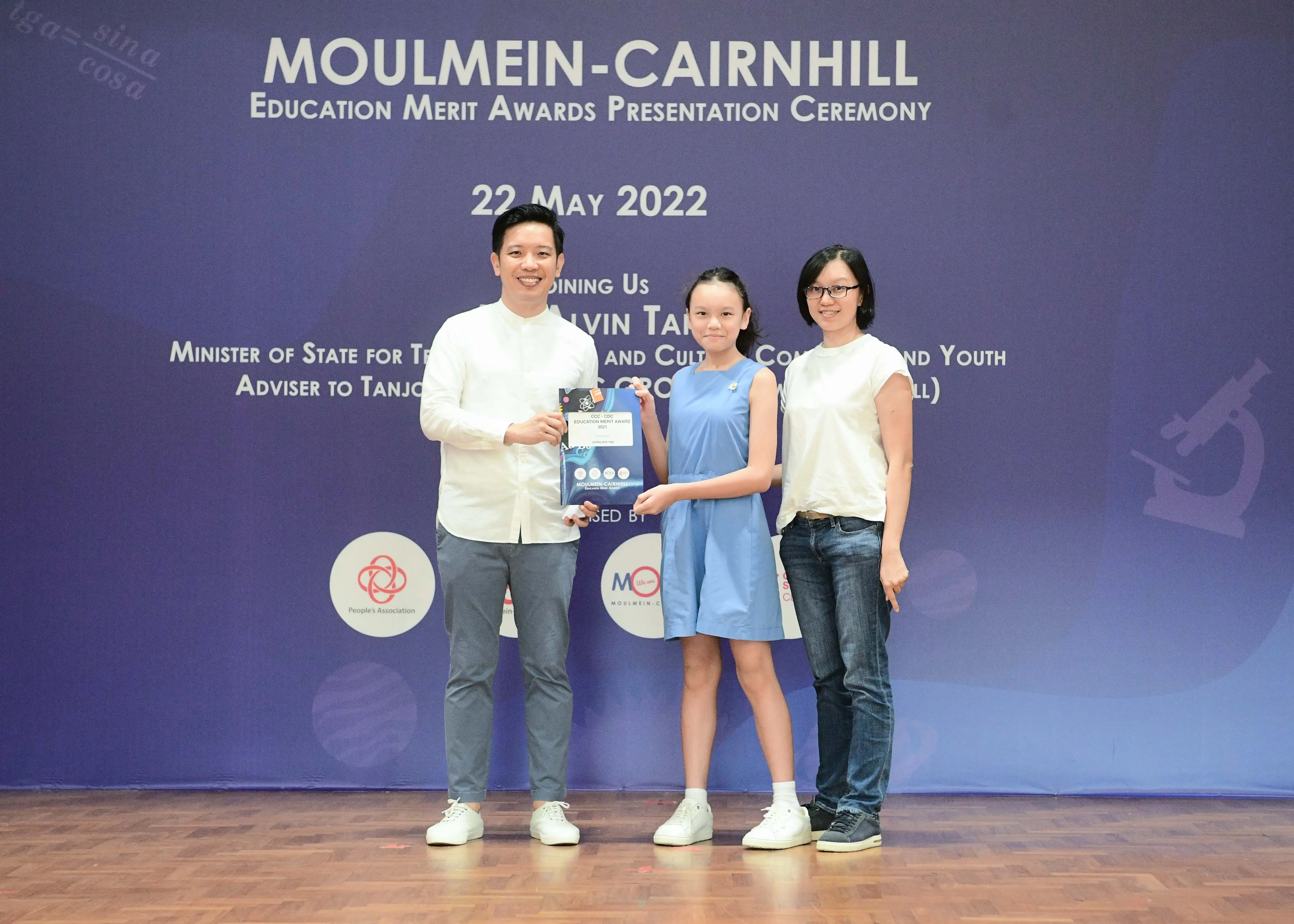 Three people pose at the Moulmein-Cairnhill Education Merit Awards Presentation Ceremony on 22 May 2022.