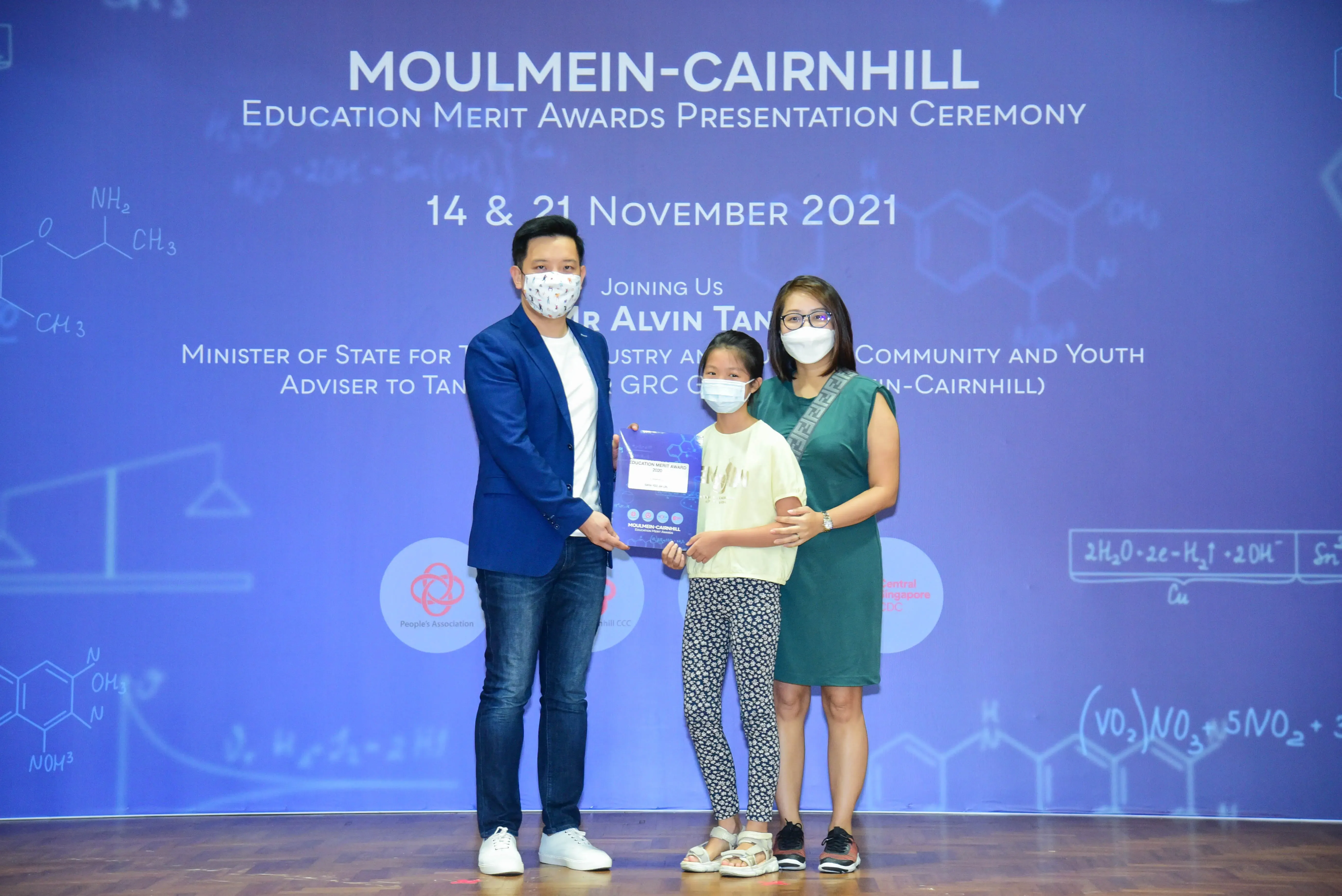 Three masked people pose at the Moulmein-Cairnhill Education Merit Awards Ceremony, November 2021.