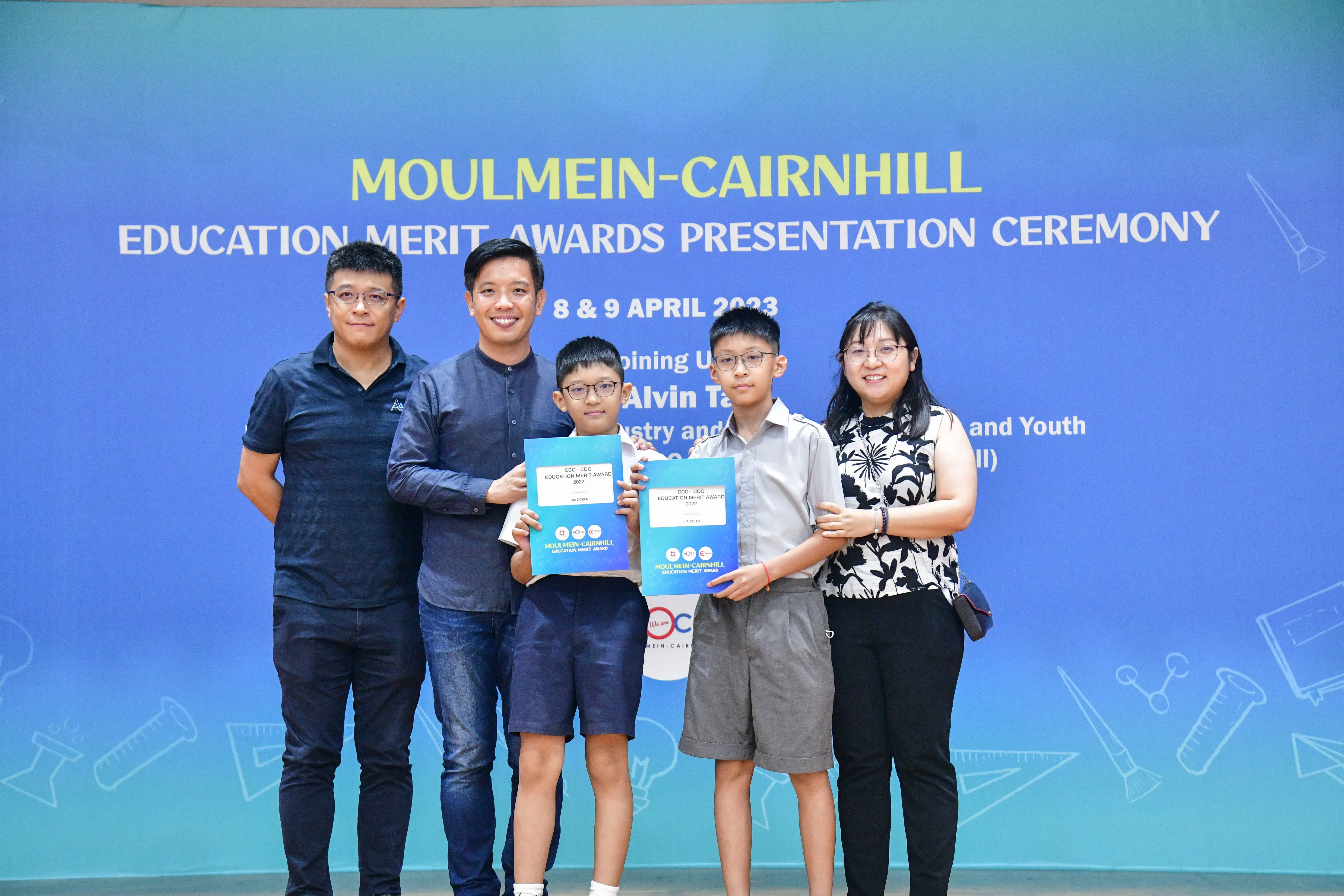 Five people pose with award certificates at the Moulmein-Cairnhill Education Merit Awards Presentation Ceremony, April 2023.