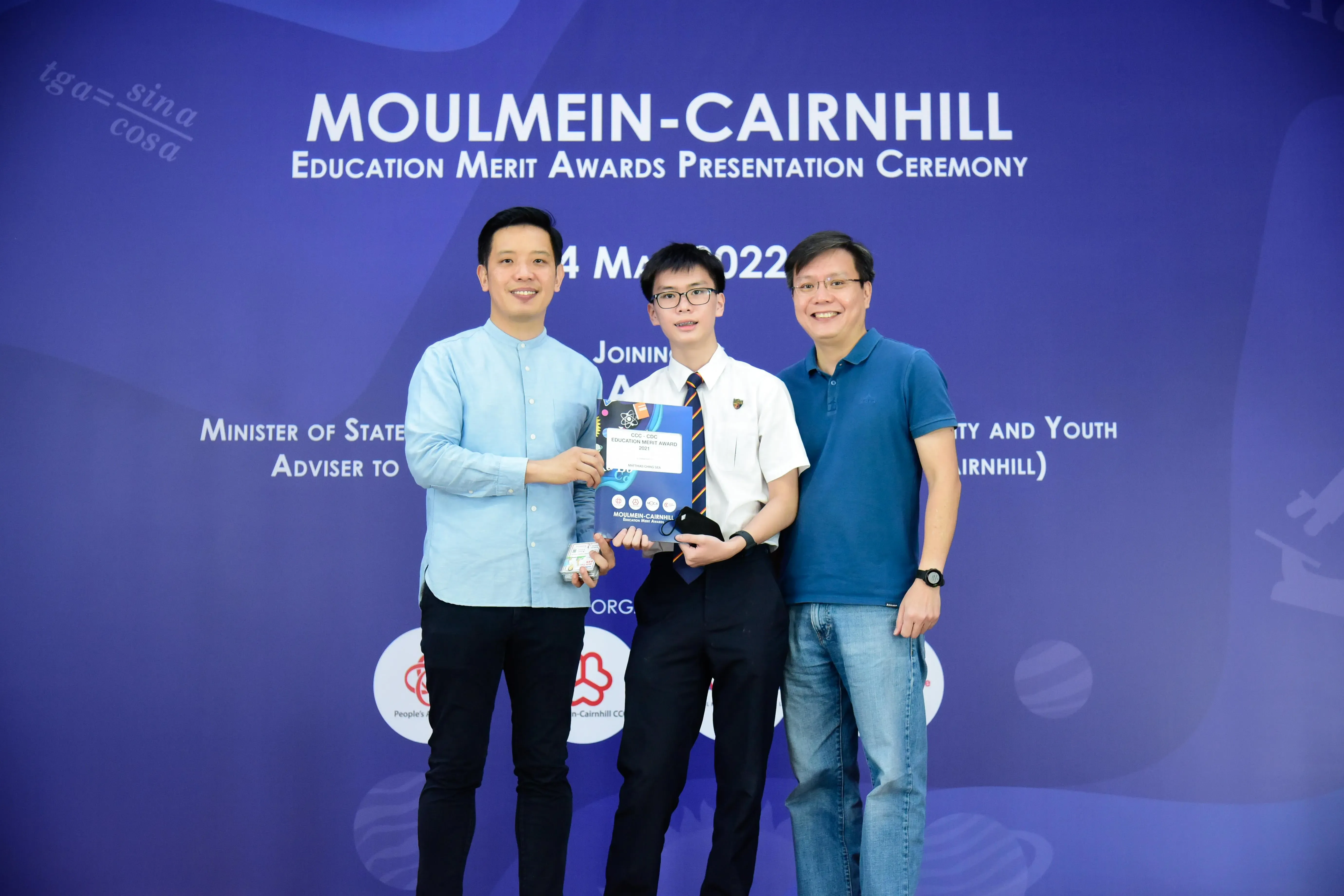 Three people pose at the Moulmein-Cairnhill Education Merit Awards Presentation Ceremony on 14 May 2022.