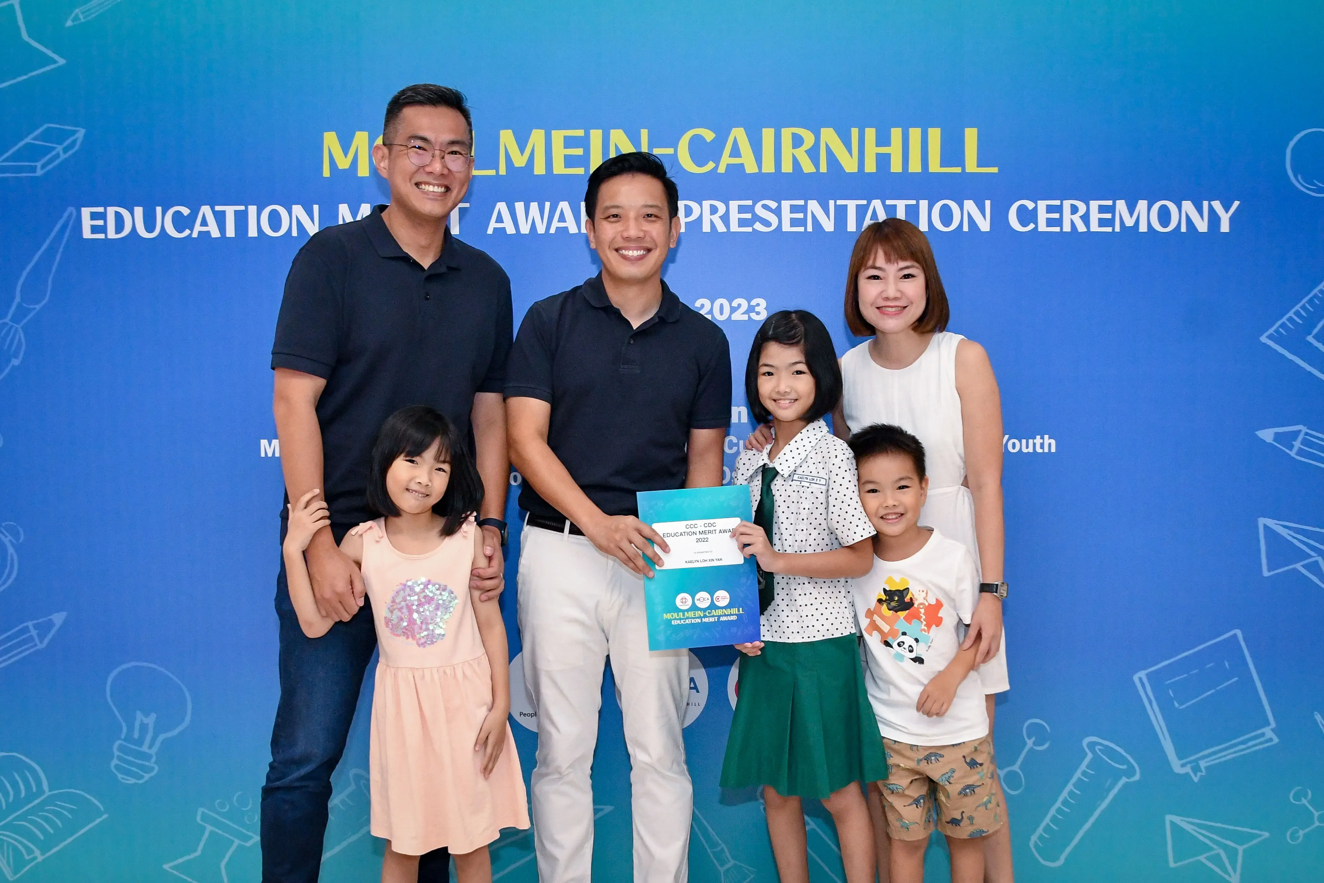 Two men, a woman, and three children pose at the 2023 Moulmein-Cairnhill Education Merit Award Presentation Ceremony.