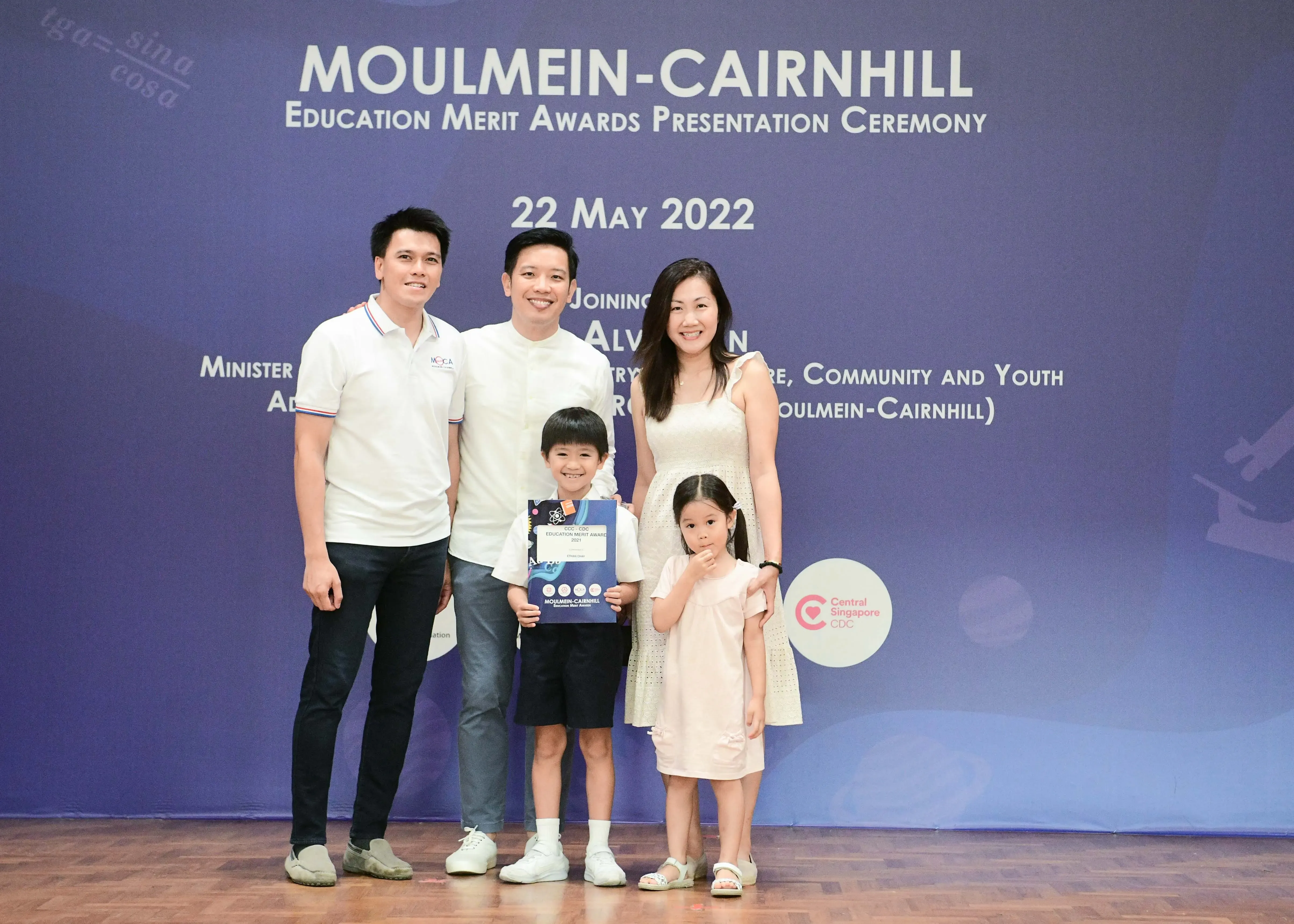 Family of five posing at Moulmein-Cairnhill Education Merit Awards Presentation Ceremony on 22 May 2022.