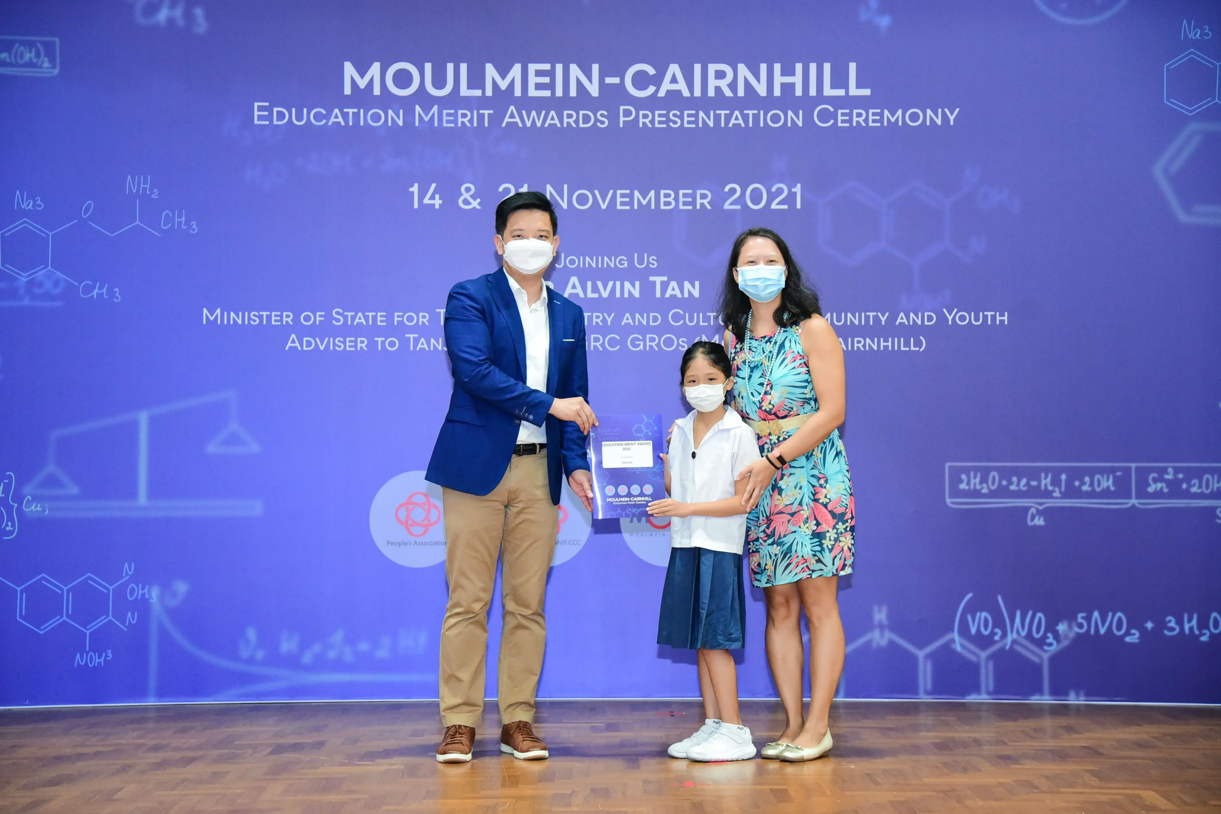 Three masked people pose at the Moulmein-Cairnhill Education Merit Awards ceremony on 14 & 21 November 2021.