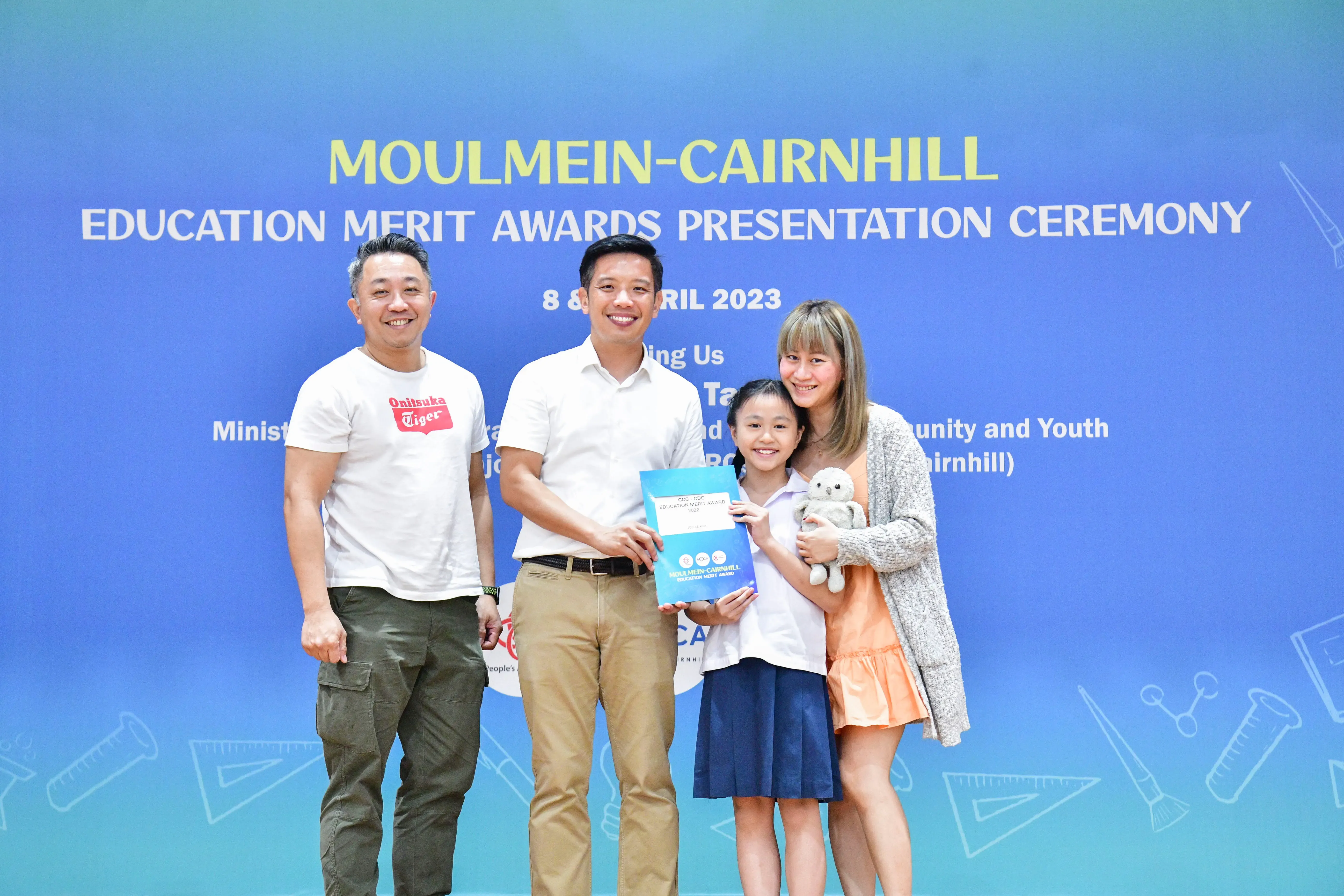 Four people pose at the Moulmein-Cairnhill Education Merit Awards Presentation Ceremony in April 2023.