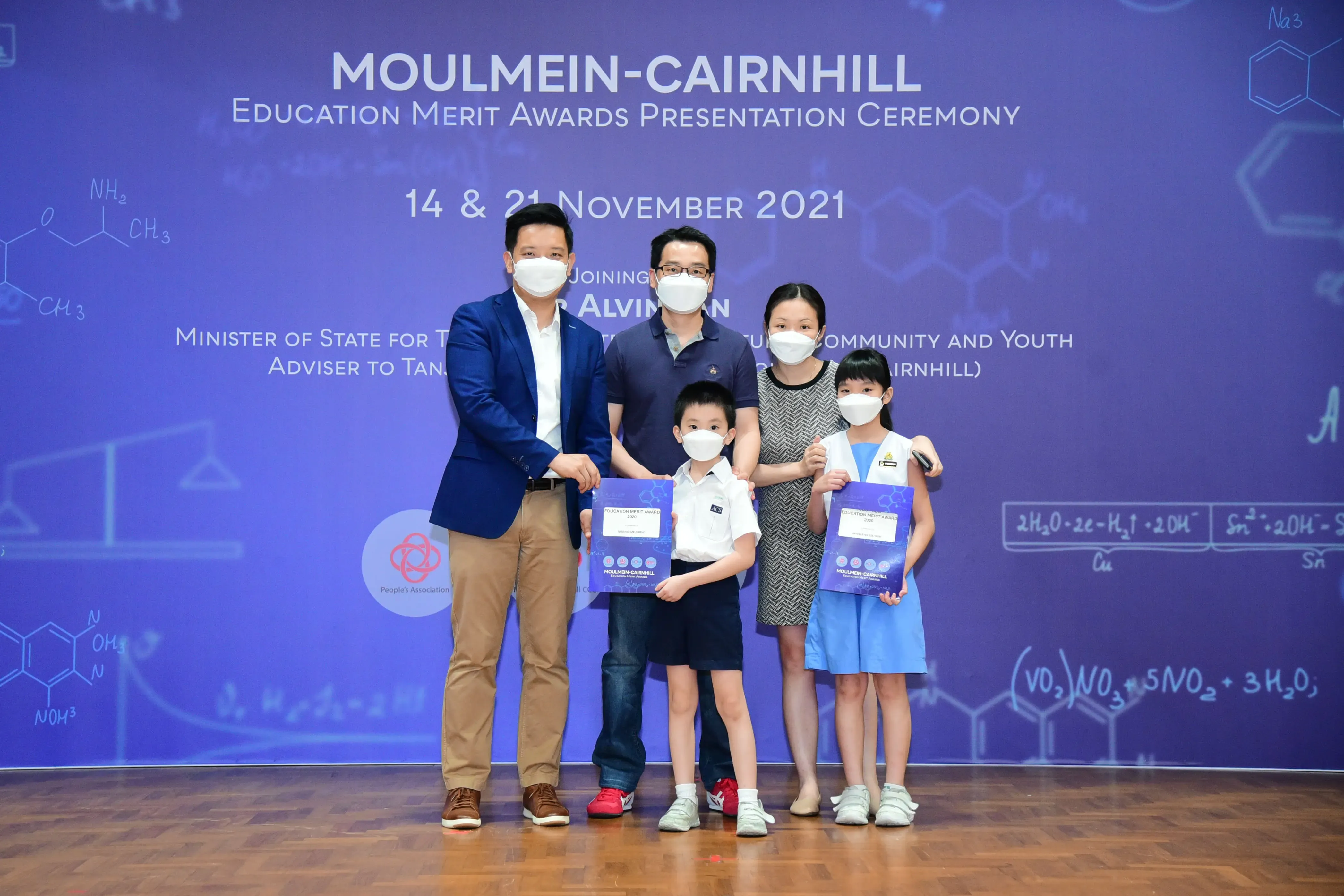 Five masked people pose at the Moulmein-Cairnhill Education Merit Awards Ceremony on November 2021.