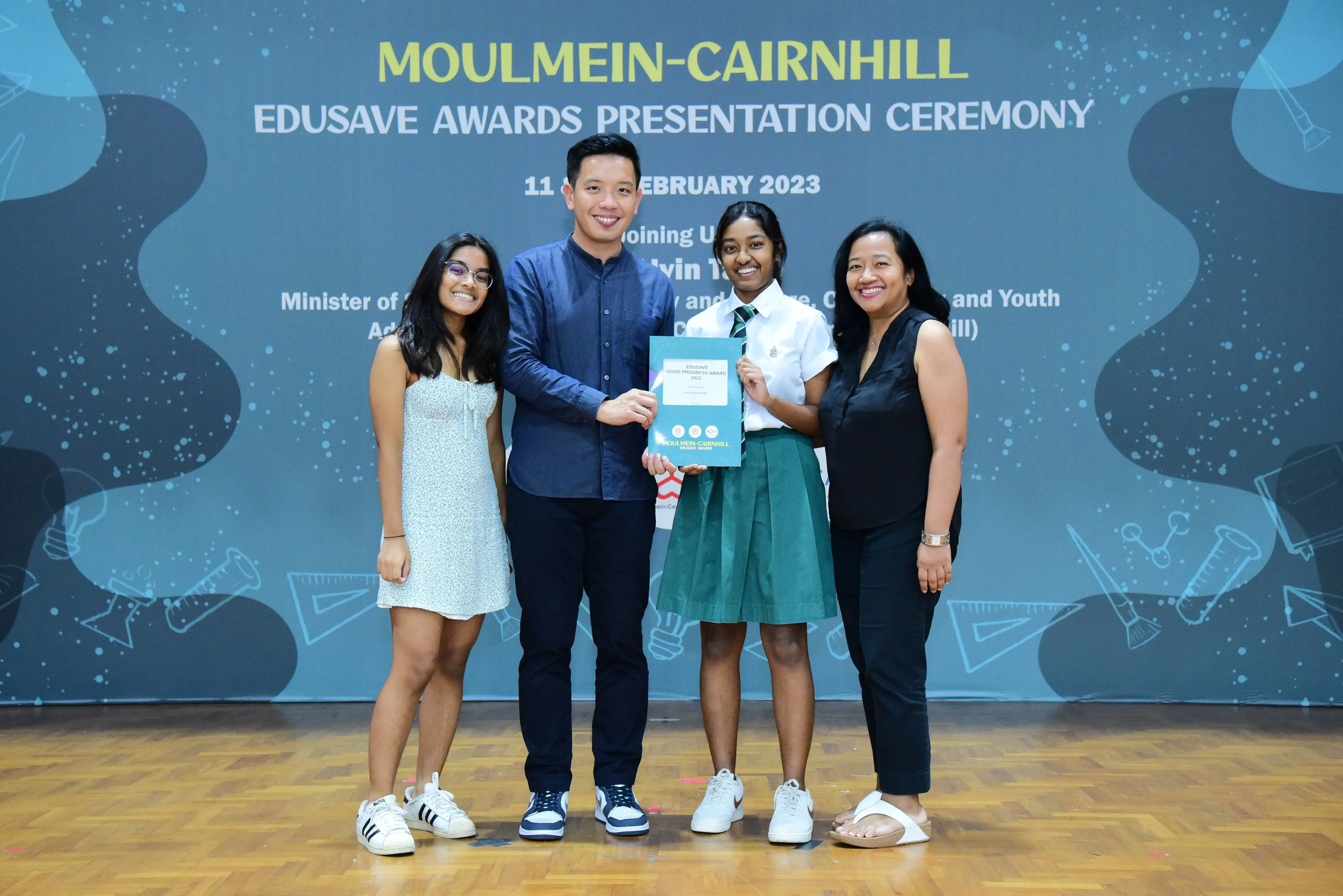 Four people pose at the Moulmein-Cairnhill Edusave Awards Presentation Ceremony on 11 February 2023.