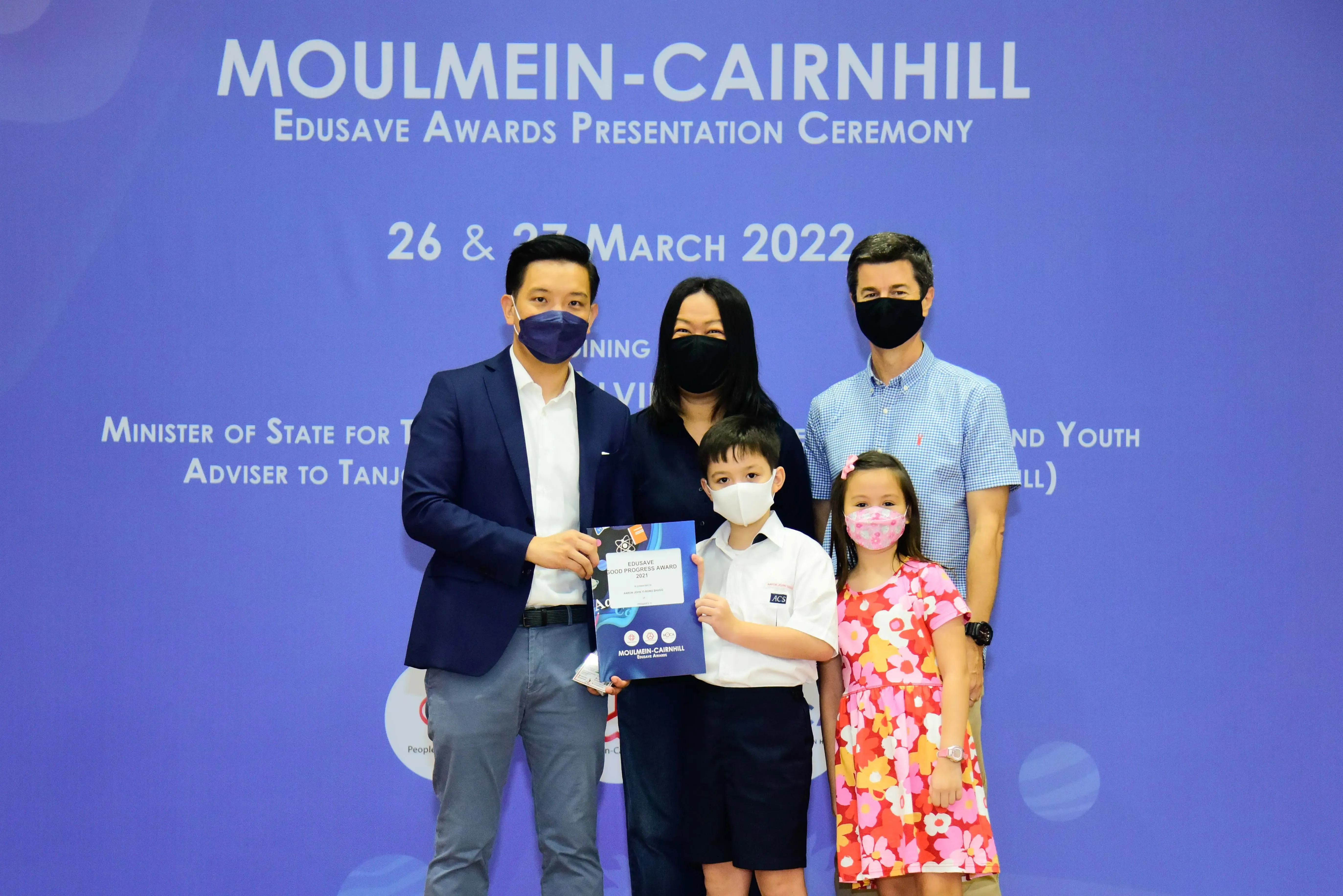 Five masked people pose at the Moulmein-Cairnhill Edusave Awards Ceremony on 26 & 27 March 2022.