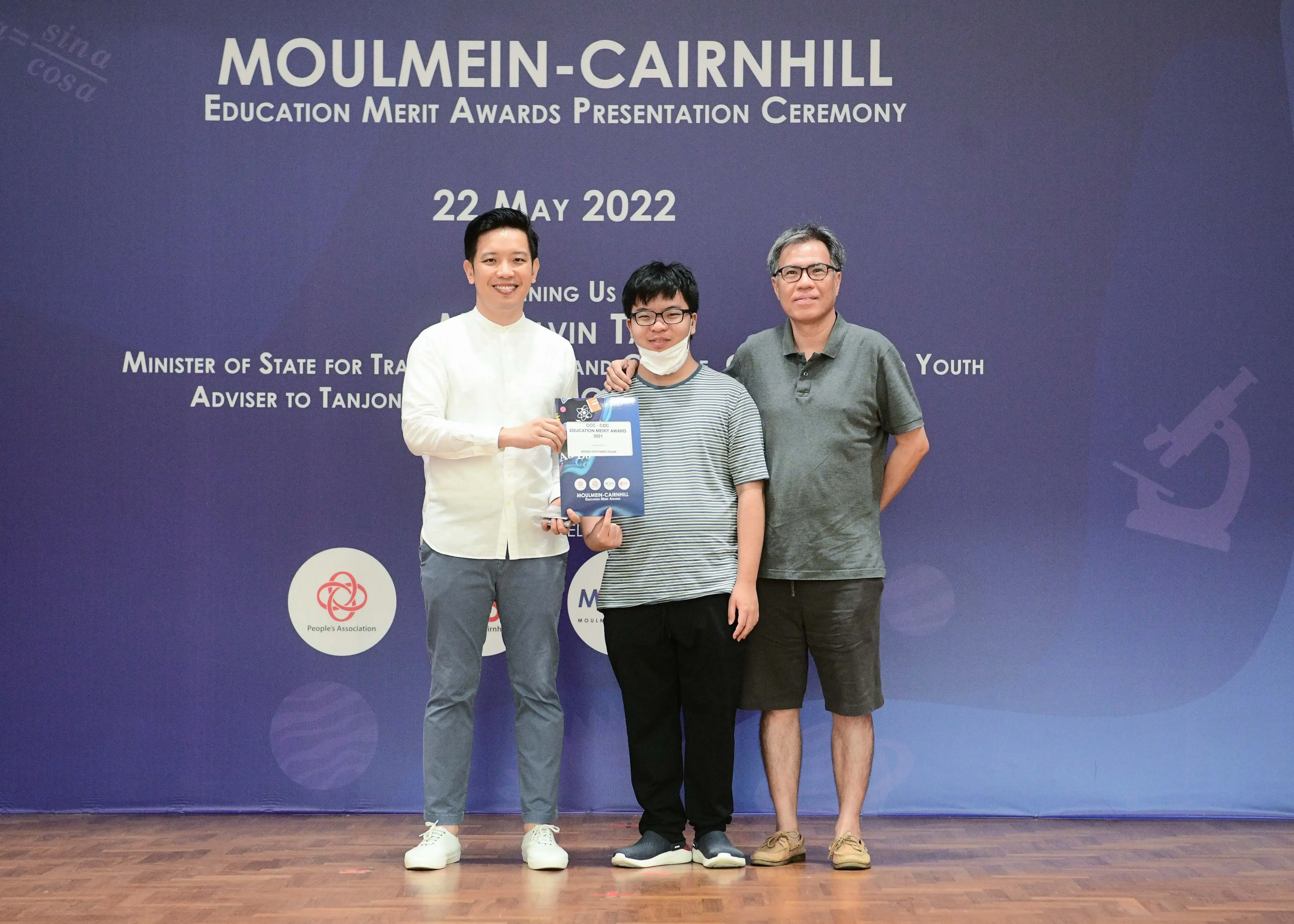 Three people pose at the Moulmein-Cairnhill Education Merit Awards Presentation Ceremony on 22 May 2022.