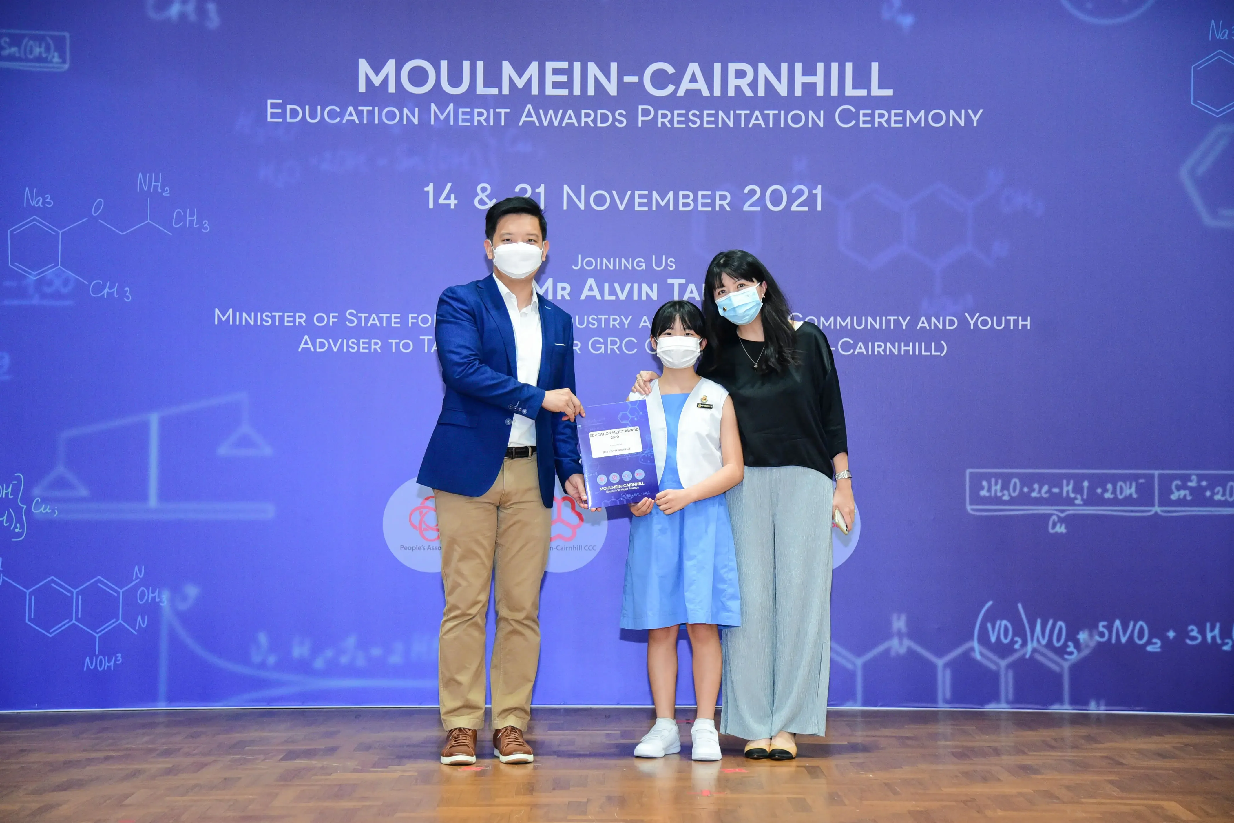 Three masked people pose at the Moulmein-Cairnhill Education Merit Awards Ceremony on 21 November 2021.