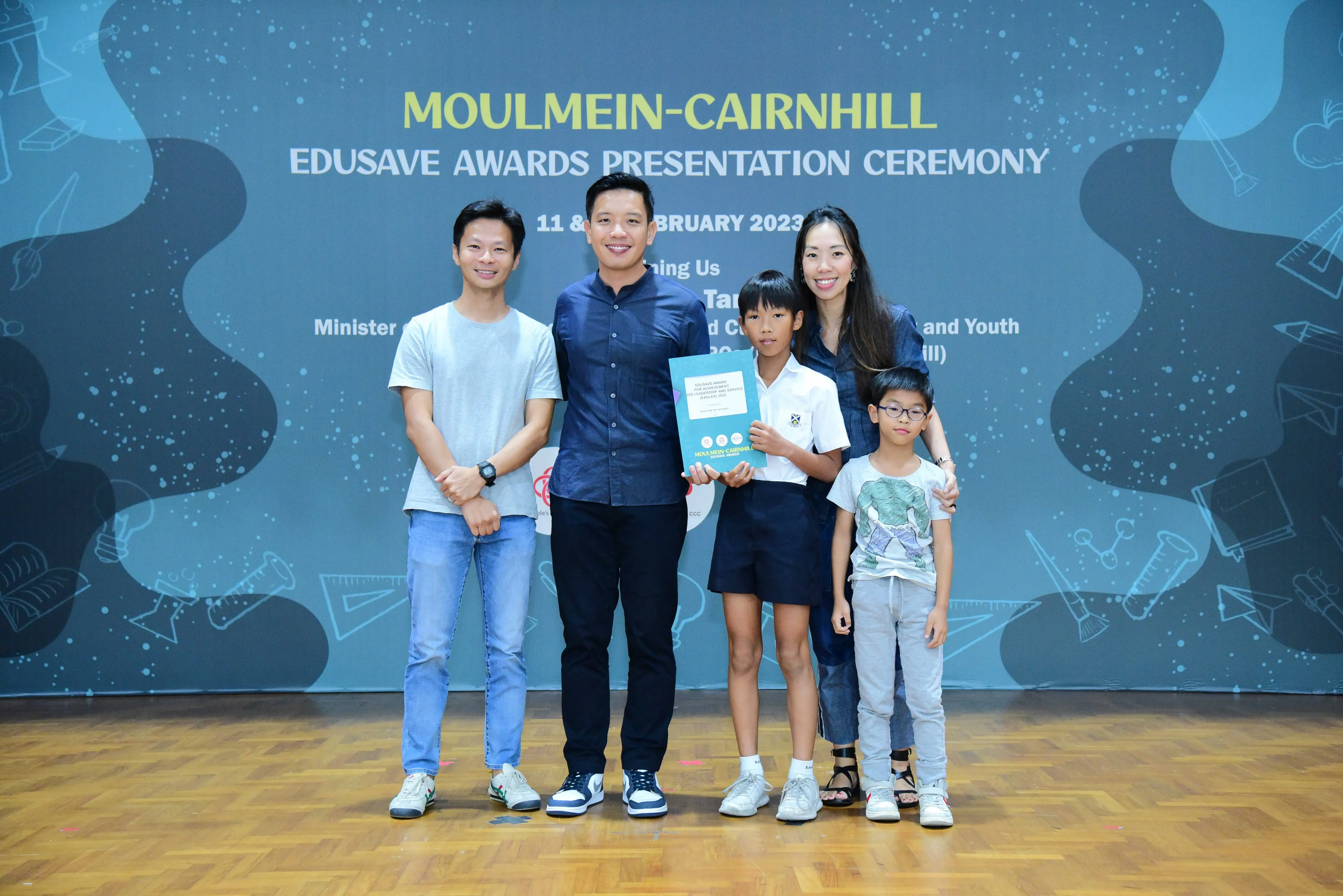 Five people pose at the Moulmein-Cairnhill Edusave Awards Presentation Ceremony in February 2023.