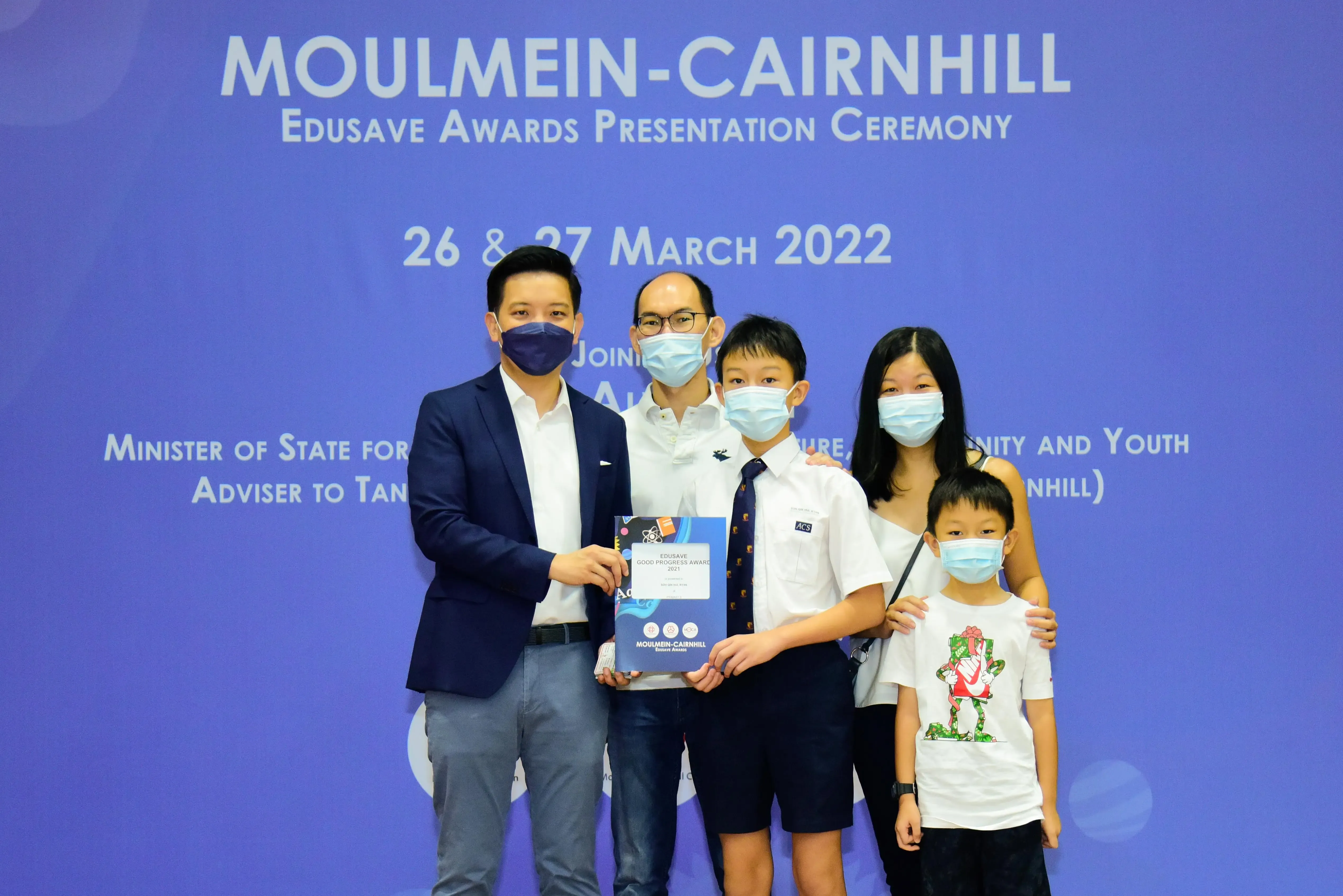 Five masked people pose at Moulmein-Cairnhill Edusave Awards Presentation Ceremony on 26 and 27 March 2022.