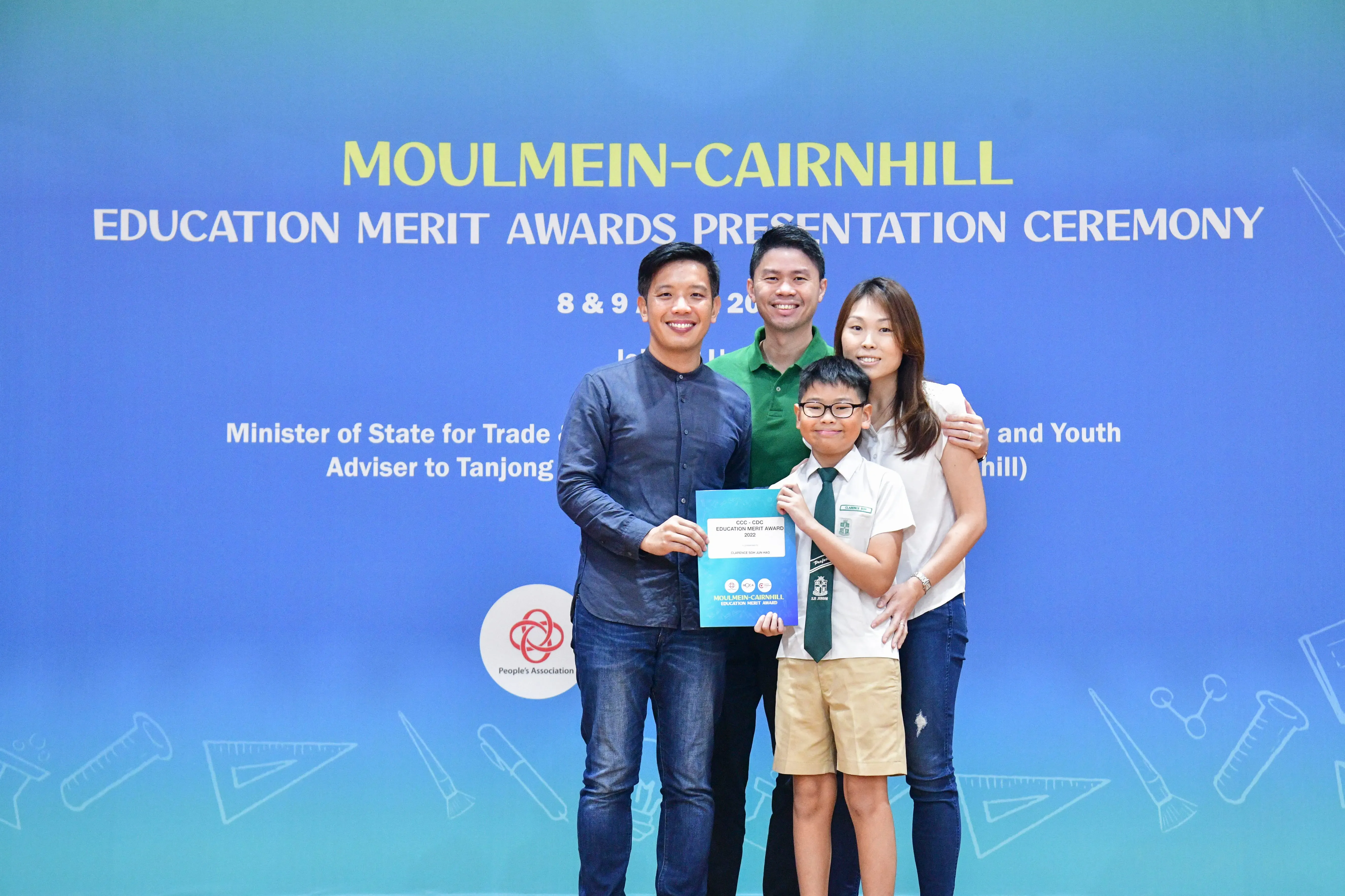 Four people pose with an award certificate at the Moulmein-Cairnhill Education Merit Awards Presentation Ceremony.