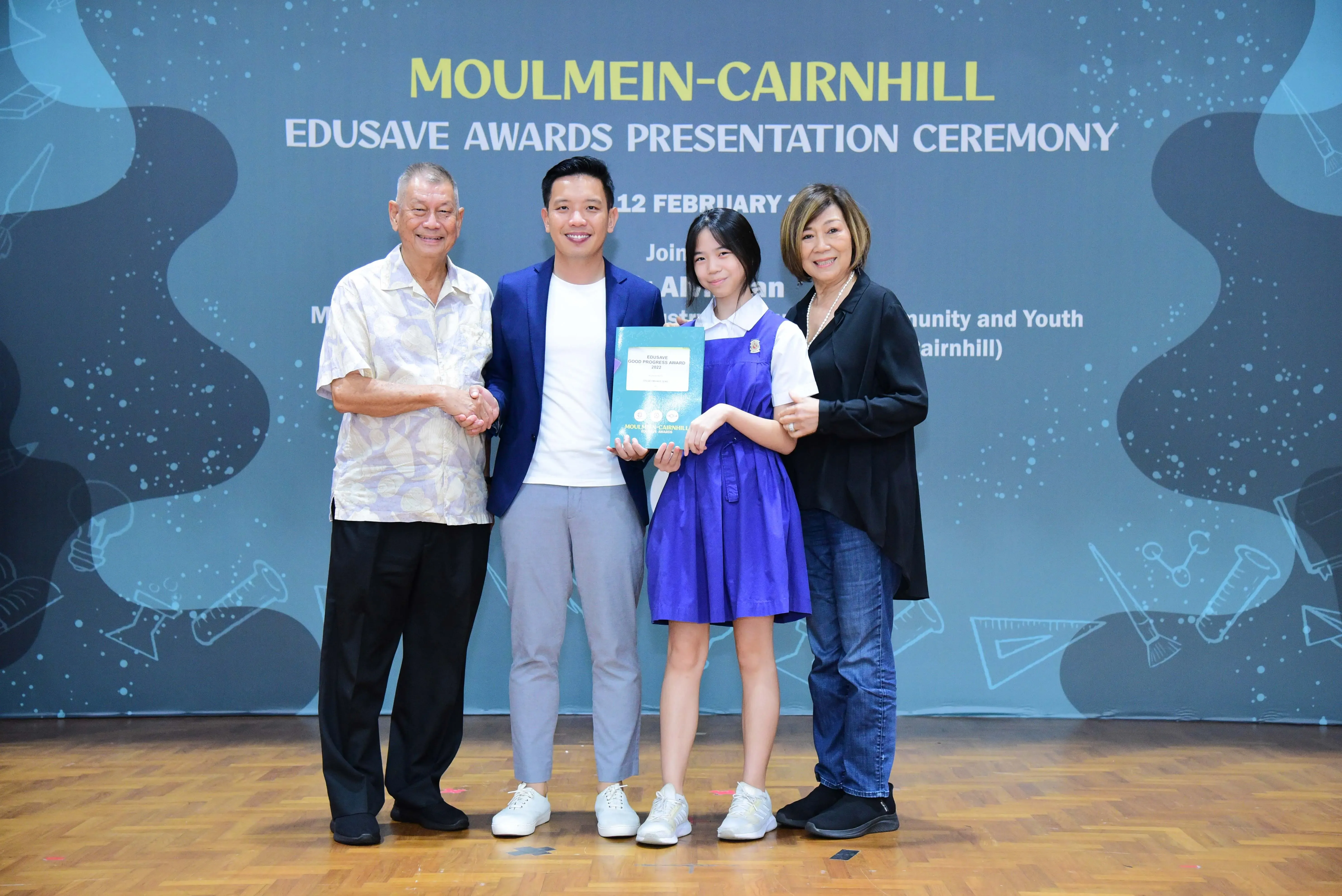 Four people pose at the Moulmein-Cairnhill Edusave Awards Presentation Ceremony; a student holds an award certificate.