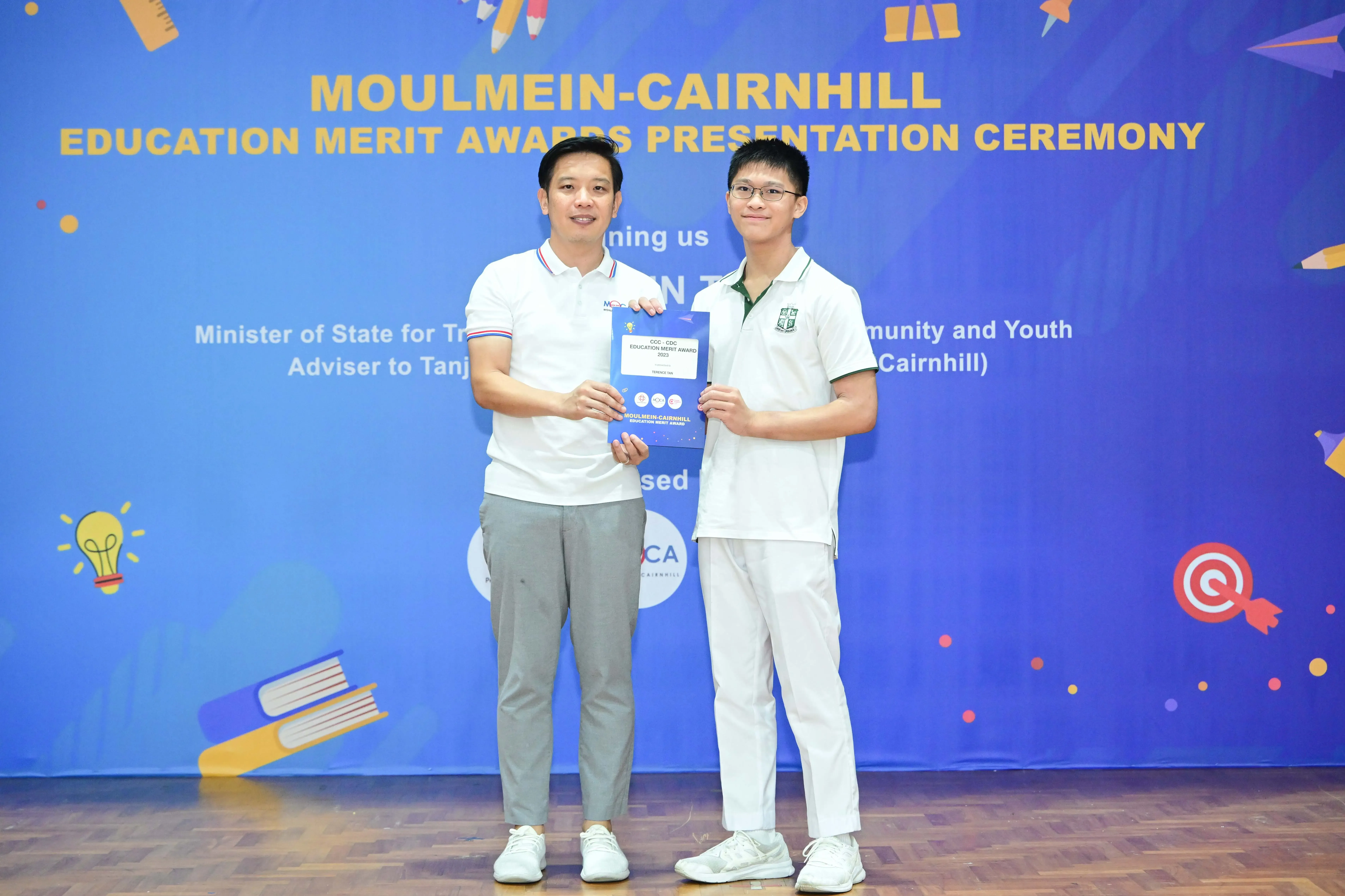 Two men pose holding a certificate at the Moulmein-Cairnhill Education Merit Awards Presentation Ceremony.