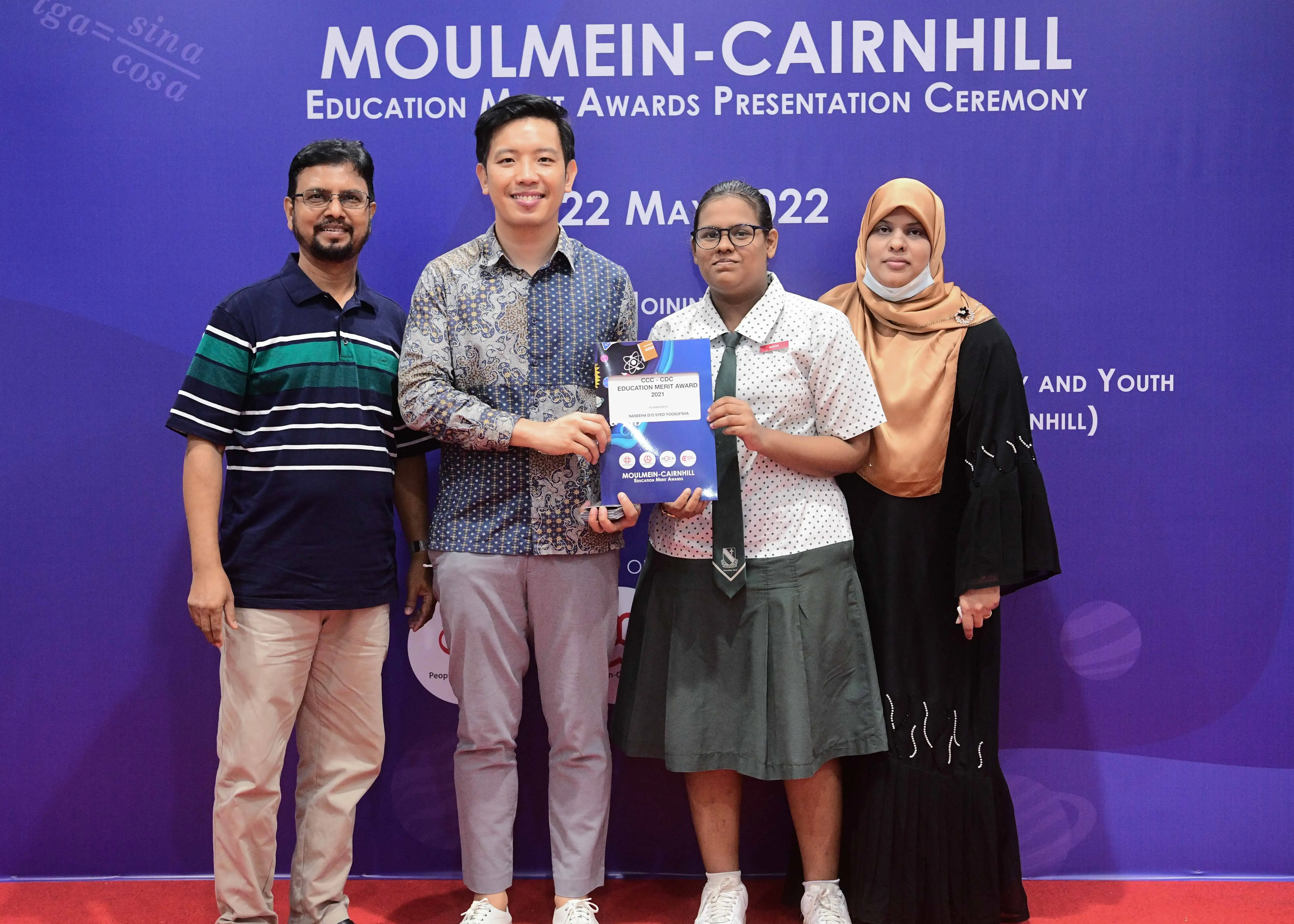 Four people pose together at the Moulmein-Cairnhill Education Merit Awards Presentation Ceremony on 22 May 2022.