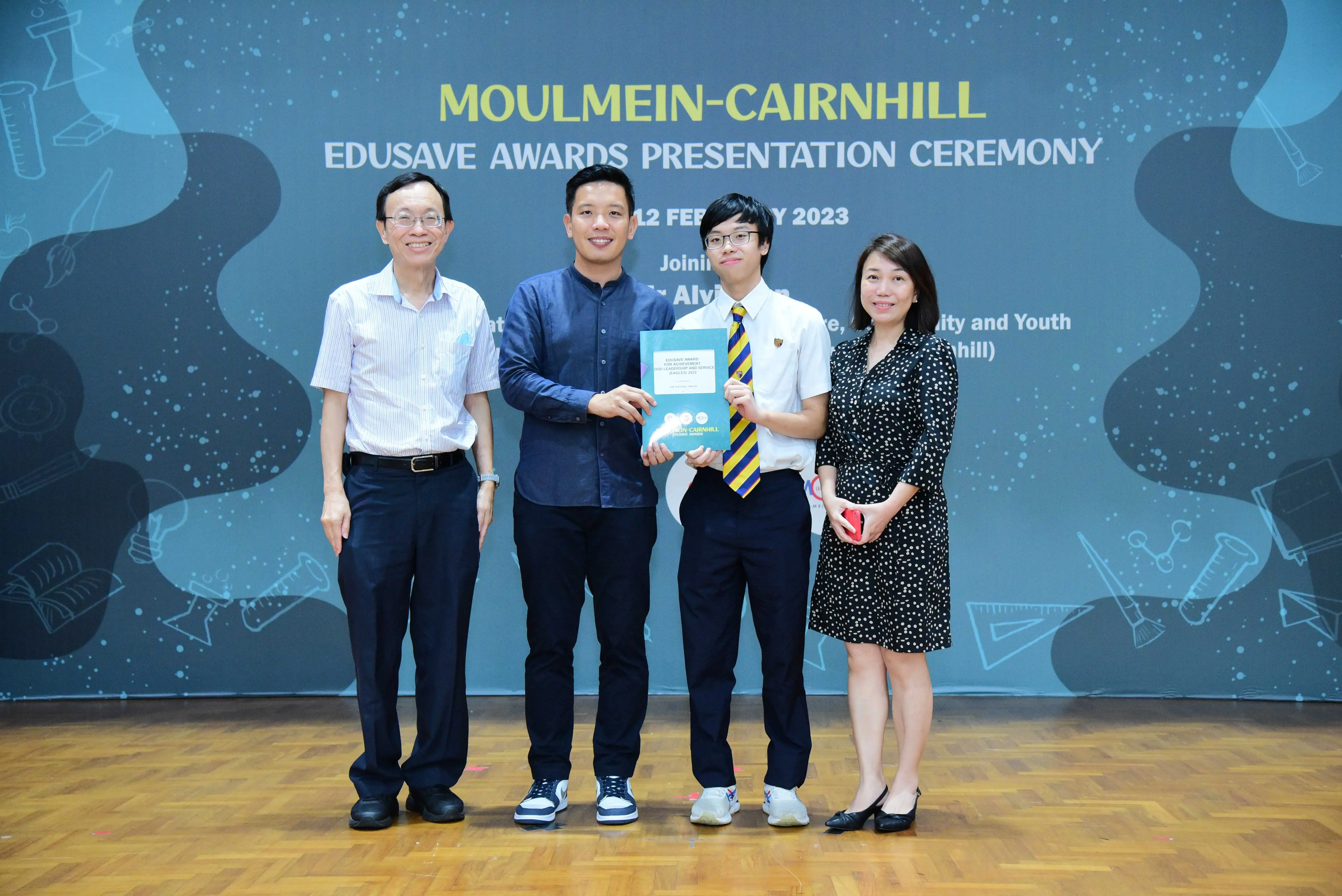 Four people pose at the Moulmein-Cairnhill Edusave Awards Presentation Ceremony on 12 February 2023.
