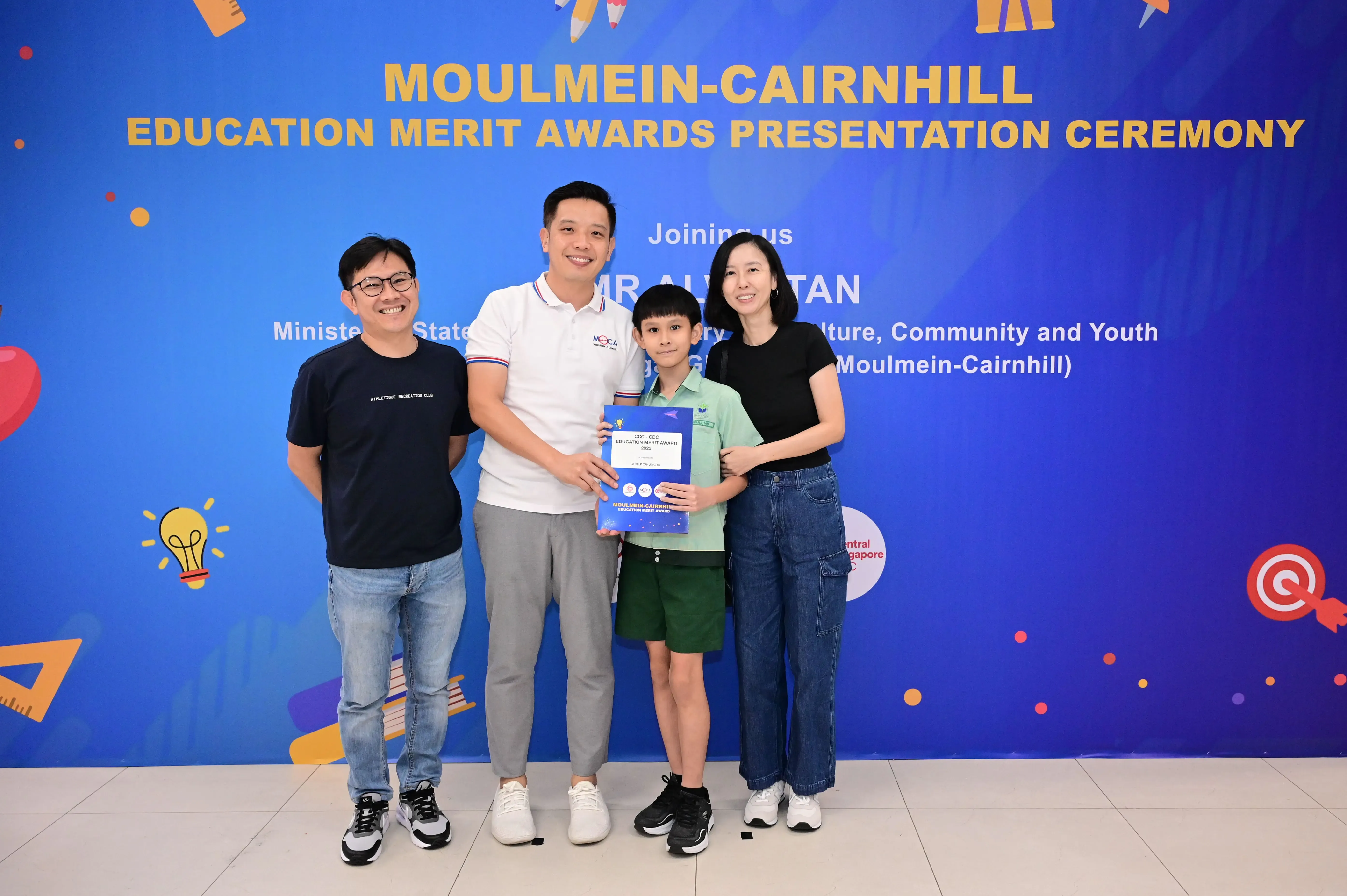 Four people pose with an award certificate at the Moulmein-Cairnhill Education Merit Awards Presentation Ceremony.