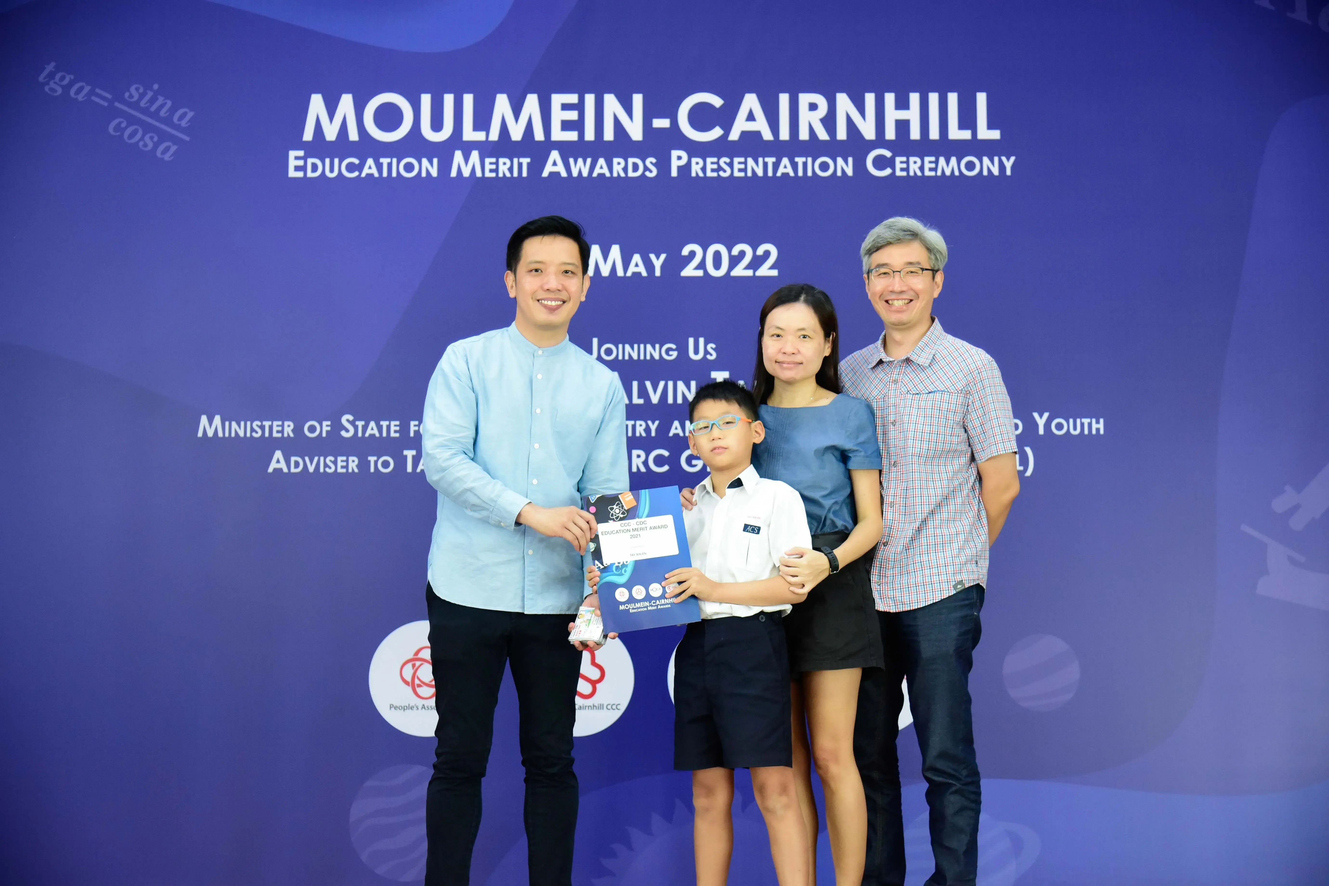 Four people pose at the Moulmein-Cairnhill Education Merit Awards Presentation Ceremony in May 2022.