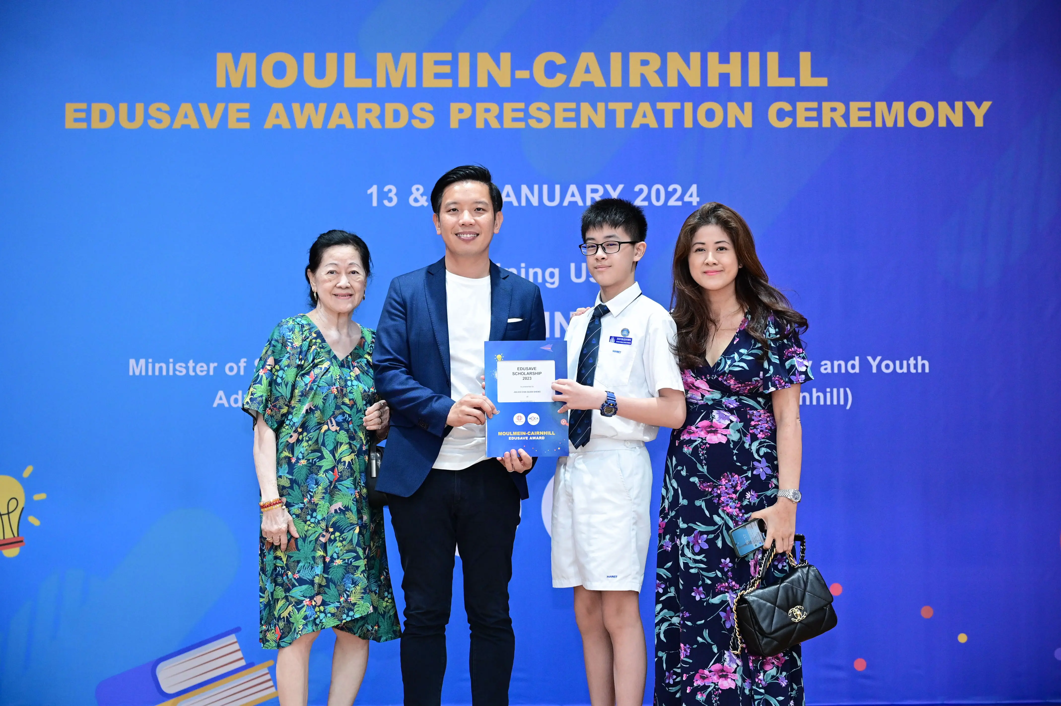 Four people pose at the Moulmein-Cairnhill Edusave Awards Presentation Ceremony in January 2024.