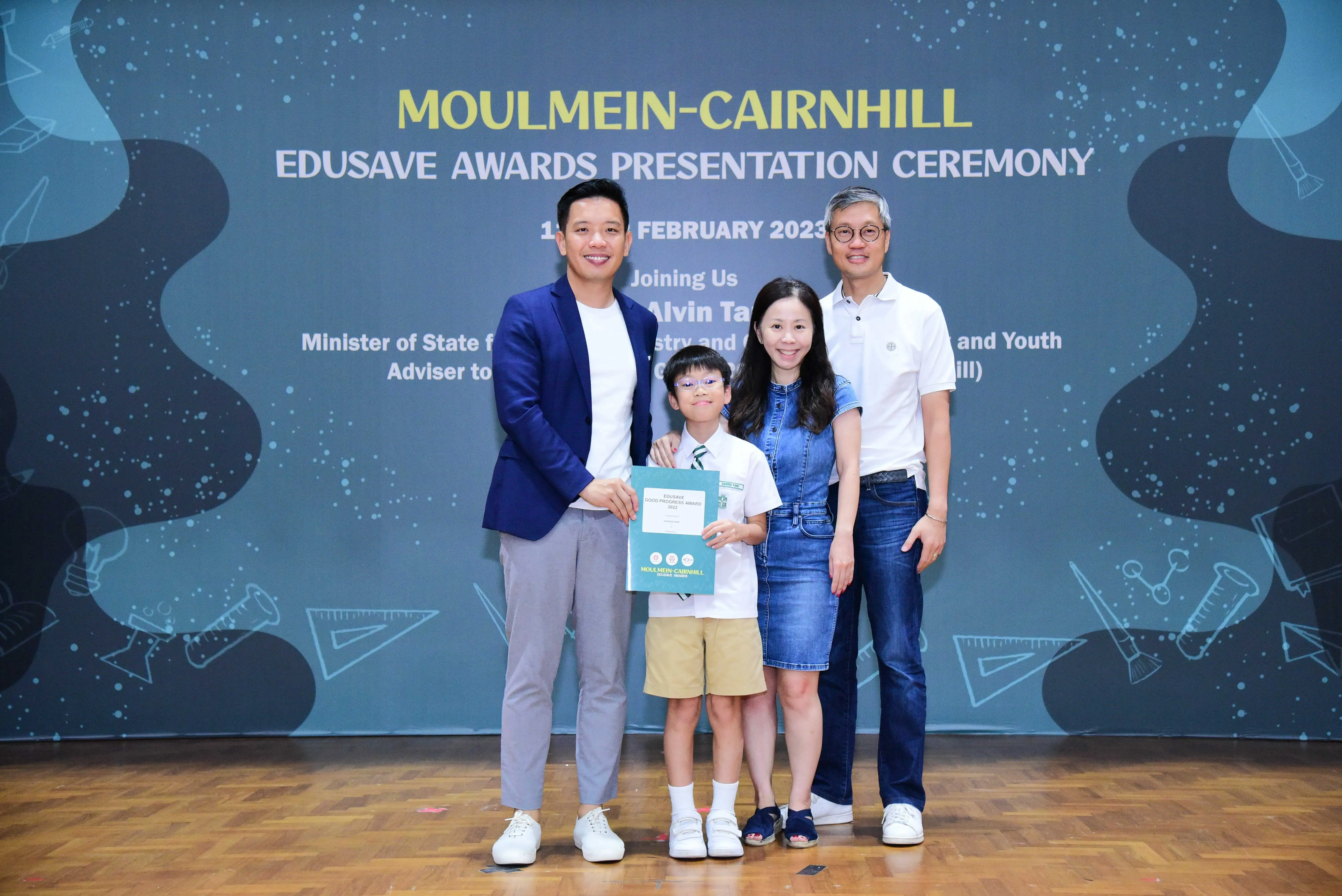 Four people pose at the Moulmein-Cairnhill Edusave Awards Presentation Ceremony in February 2023.