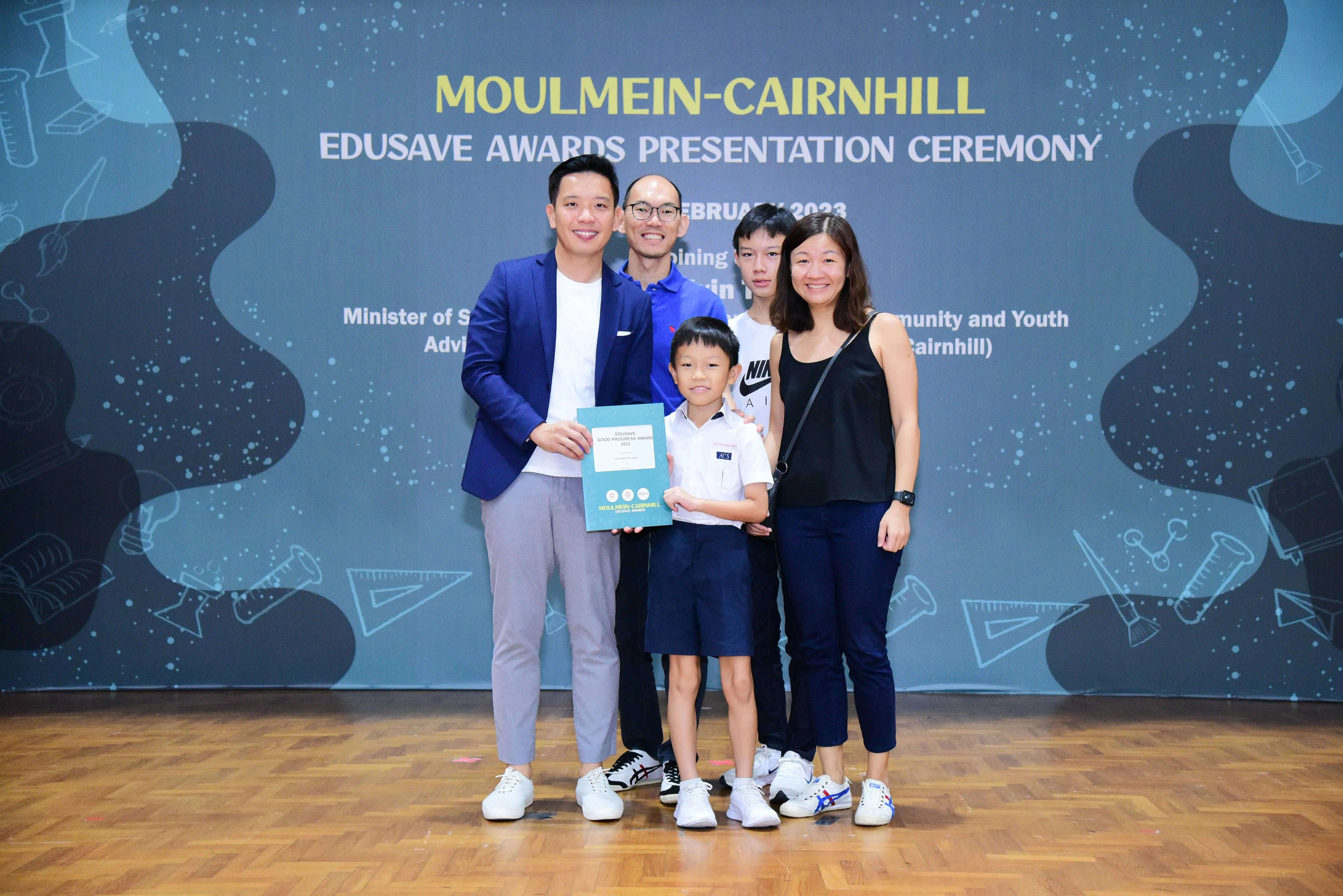 Five people pose with a certificate at the Moulmein-Cairnhill Edusave Awards Presentation Ceremony 2023.