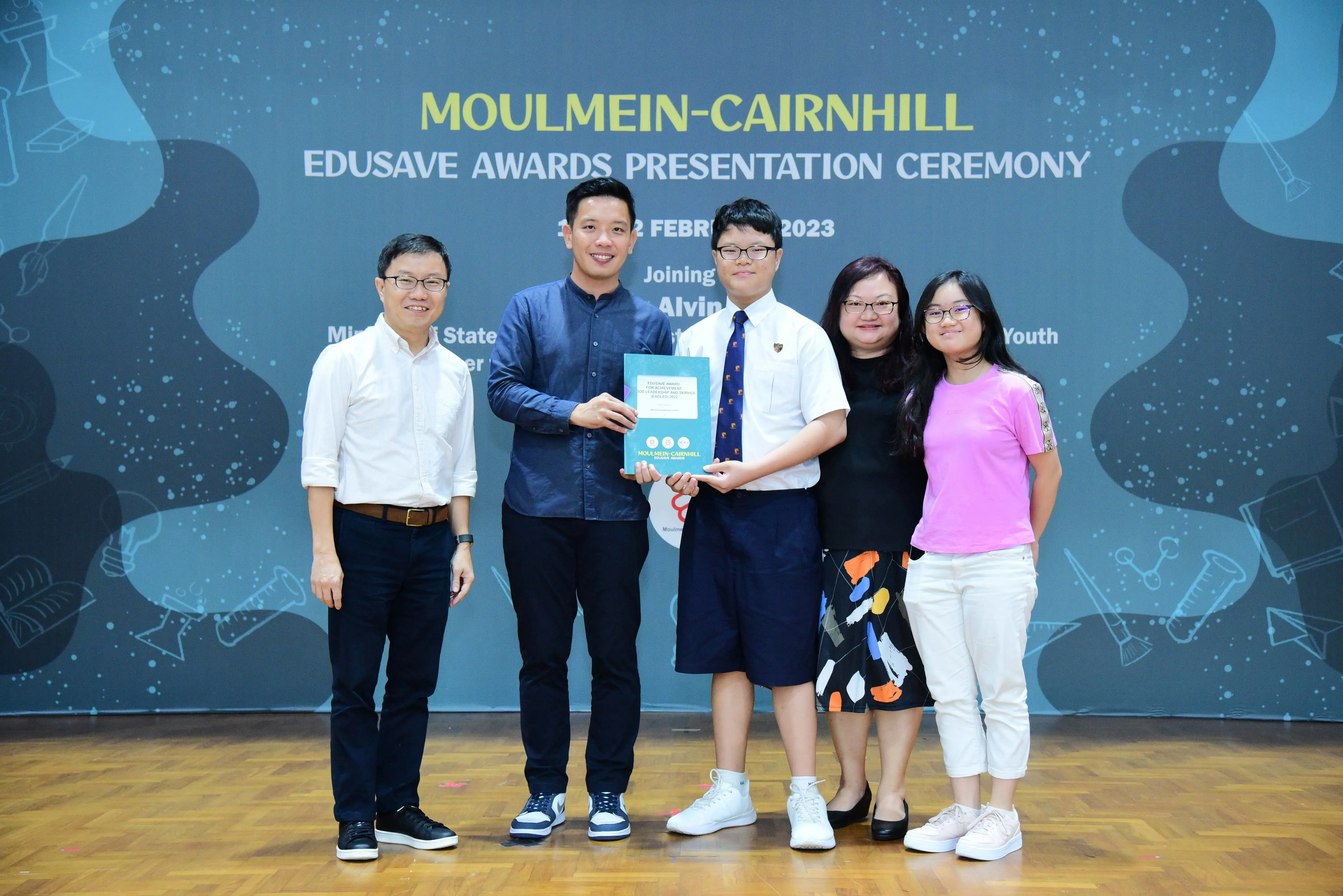 Five people pose together at the Moulmein-Cairnhill Edusave Awards Presentation Ceremony in February 2023.