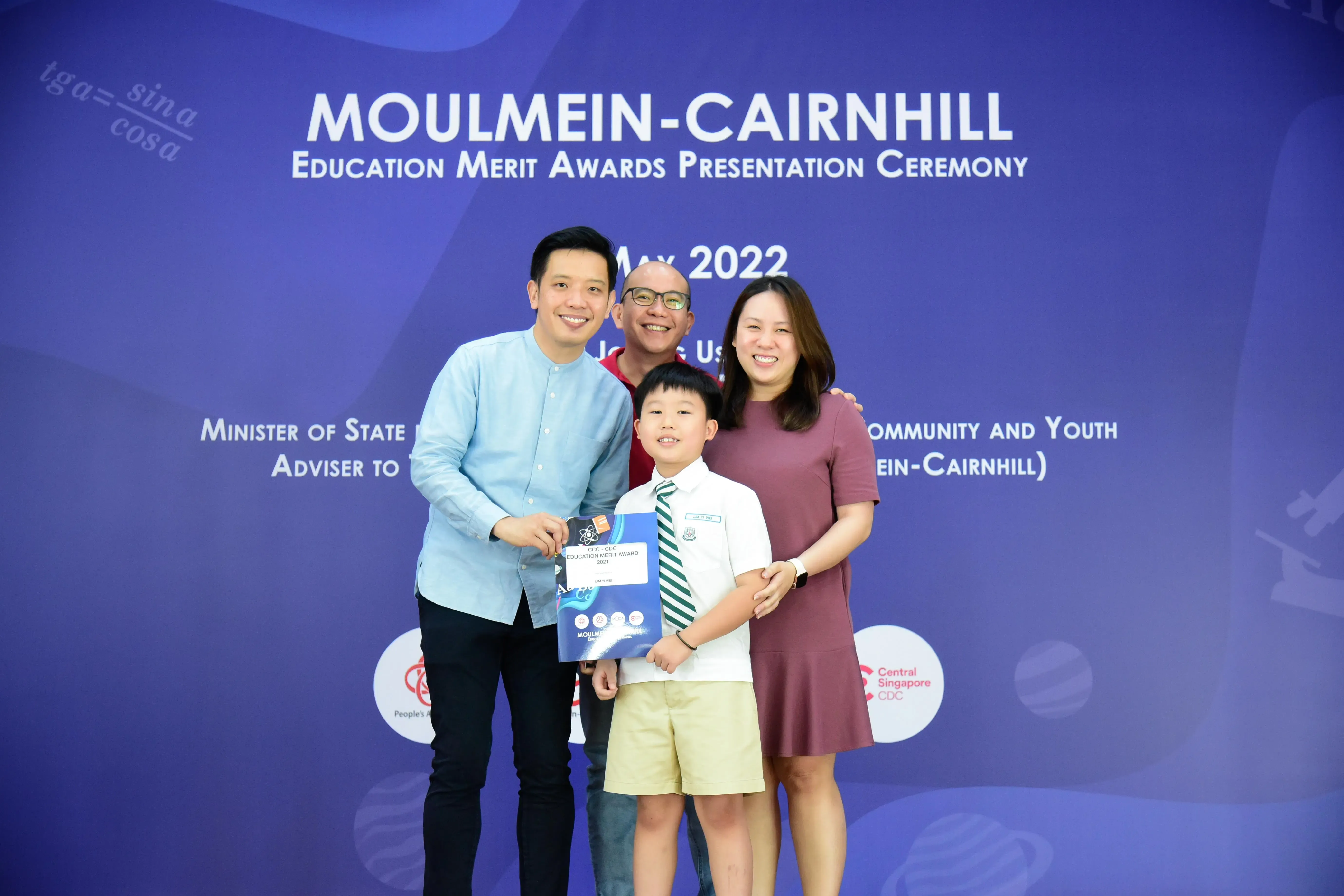Four people posing at the Moulmein-Cairnhill Education Merit Awards Presentation Ceremony in May 2022.
