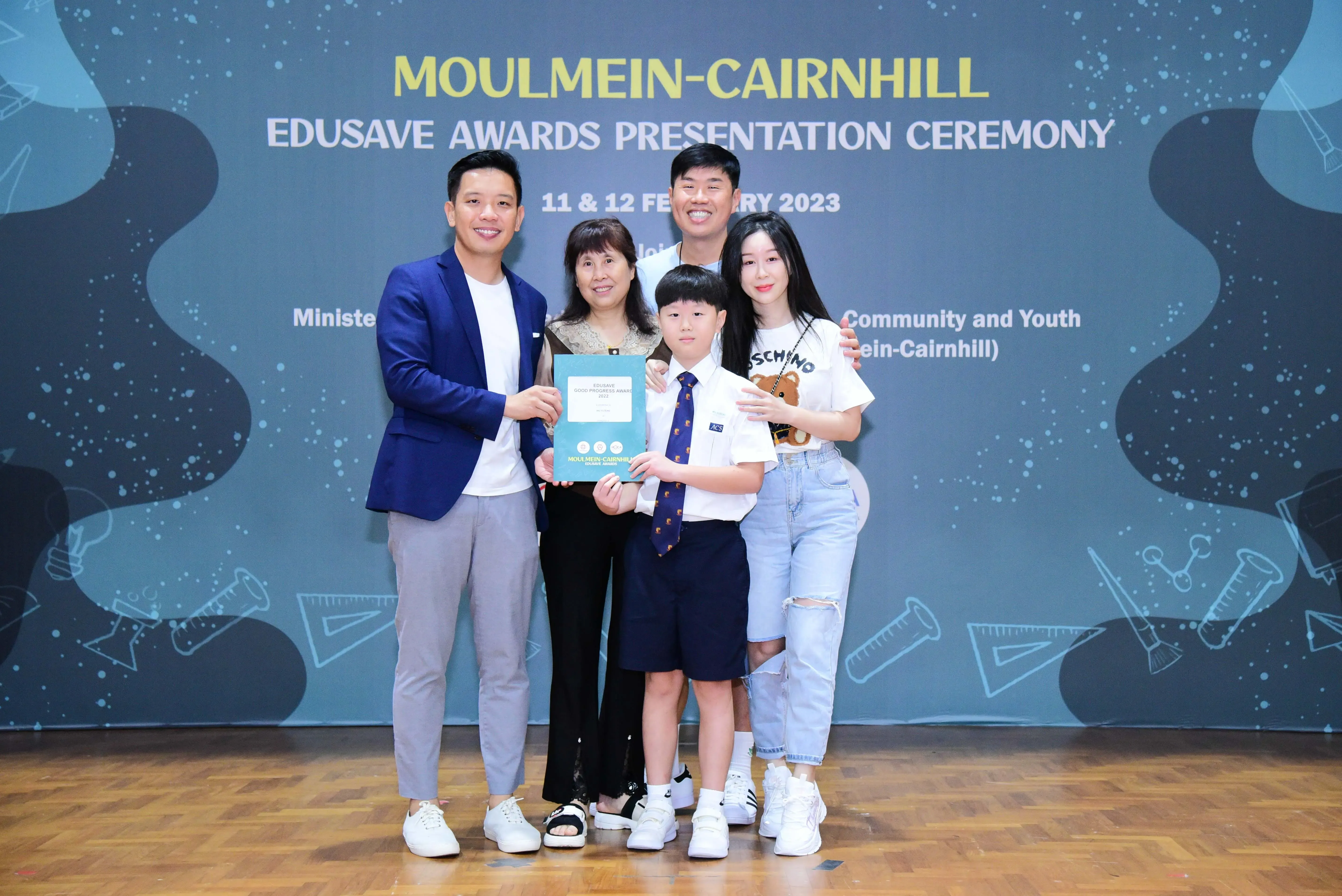 Five people pose with an award certificate at the Moulmein-Cairnhill Edusave Awards Presentation Ceremony 2023.