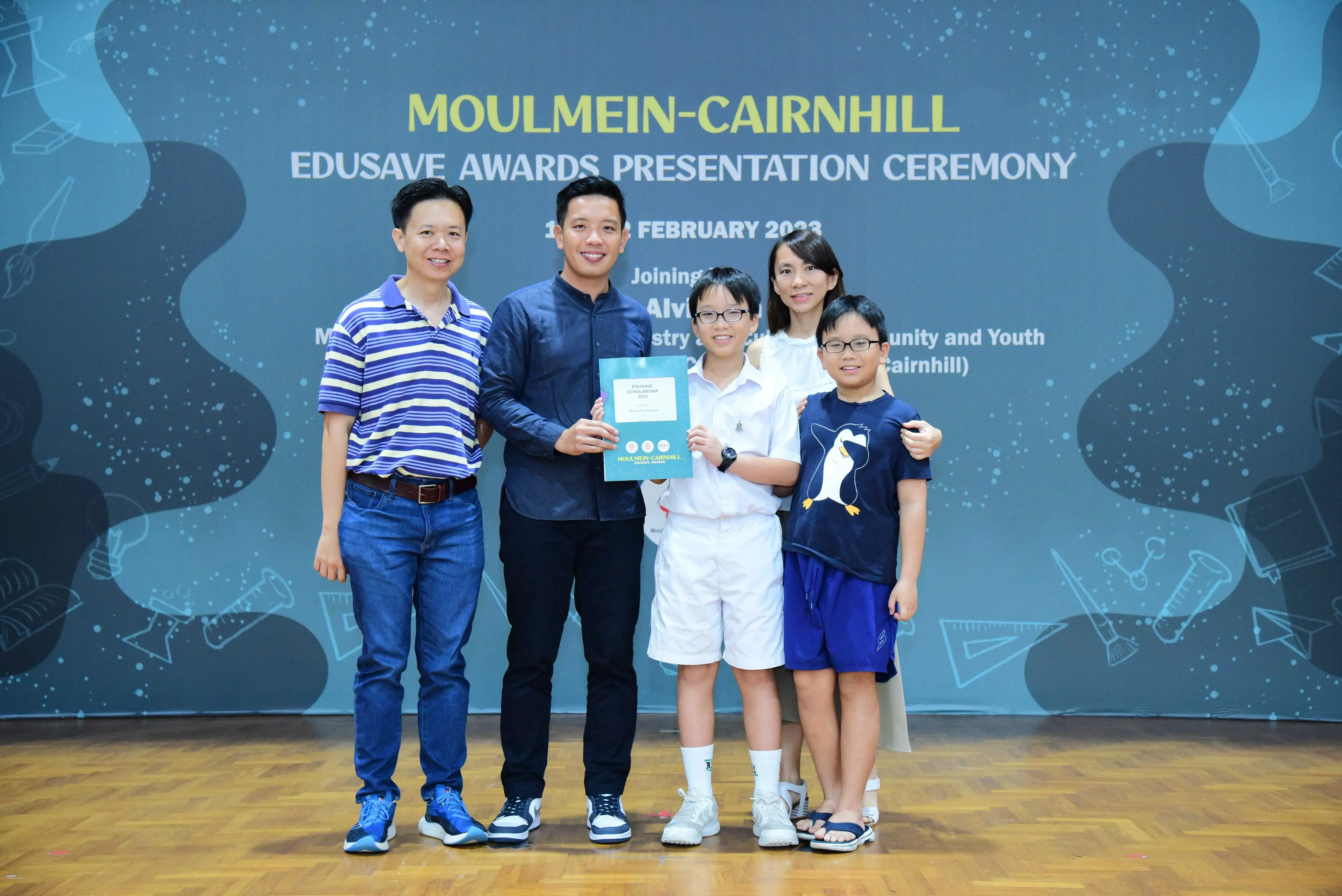 Five people pose with a certificate at the Moulmein-Cairnhill Edusave Awards Presentation Ceremony in February 2023.