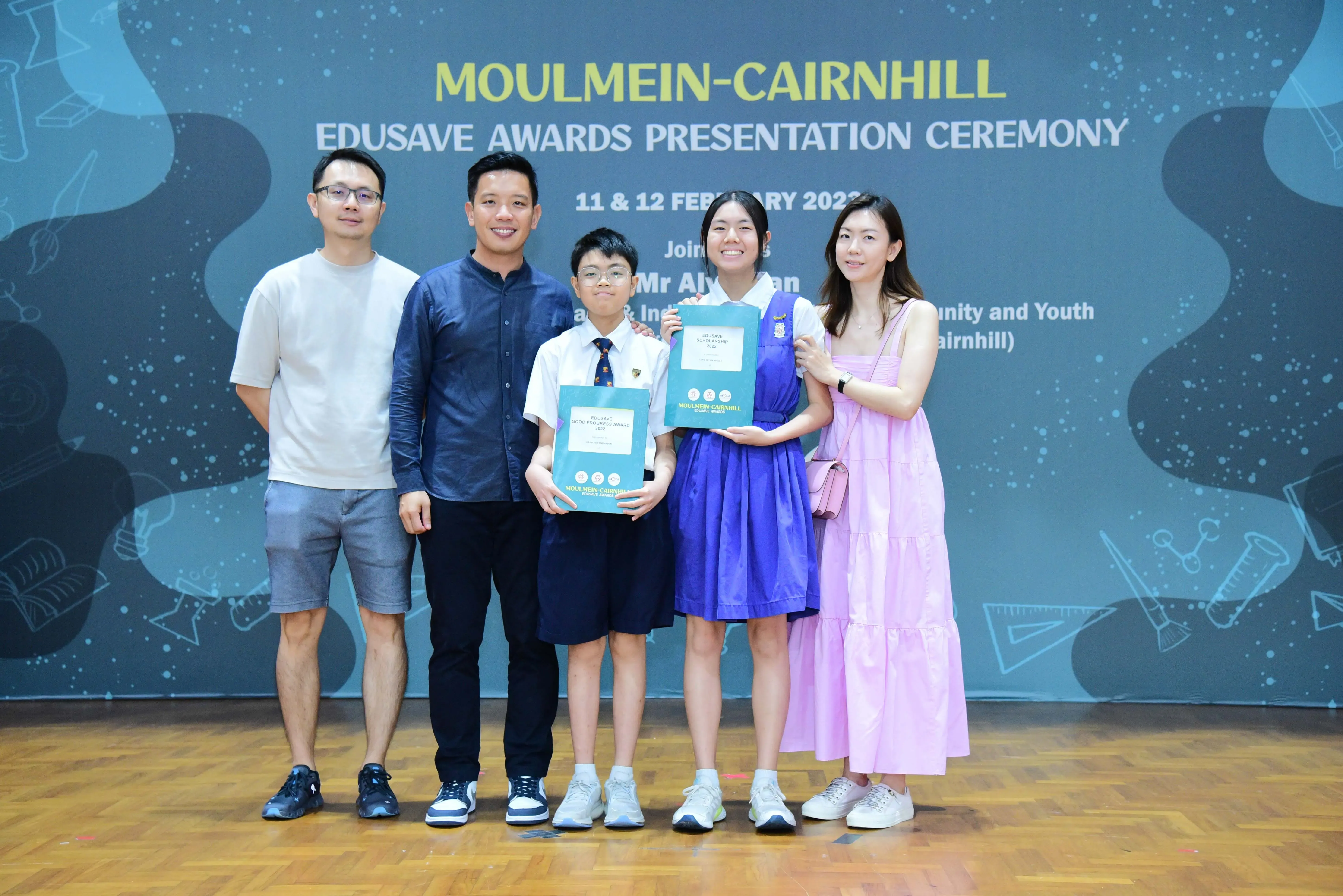 Five people pose with award certificates at the Moulmein-Cairnhill Edusave Awards Presentation Ceremony.