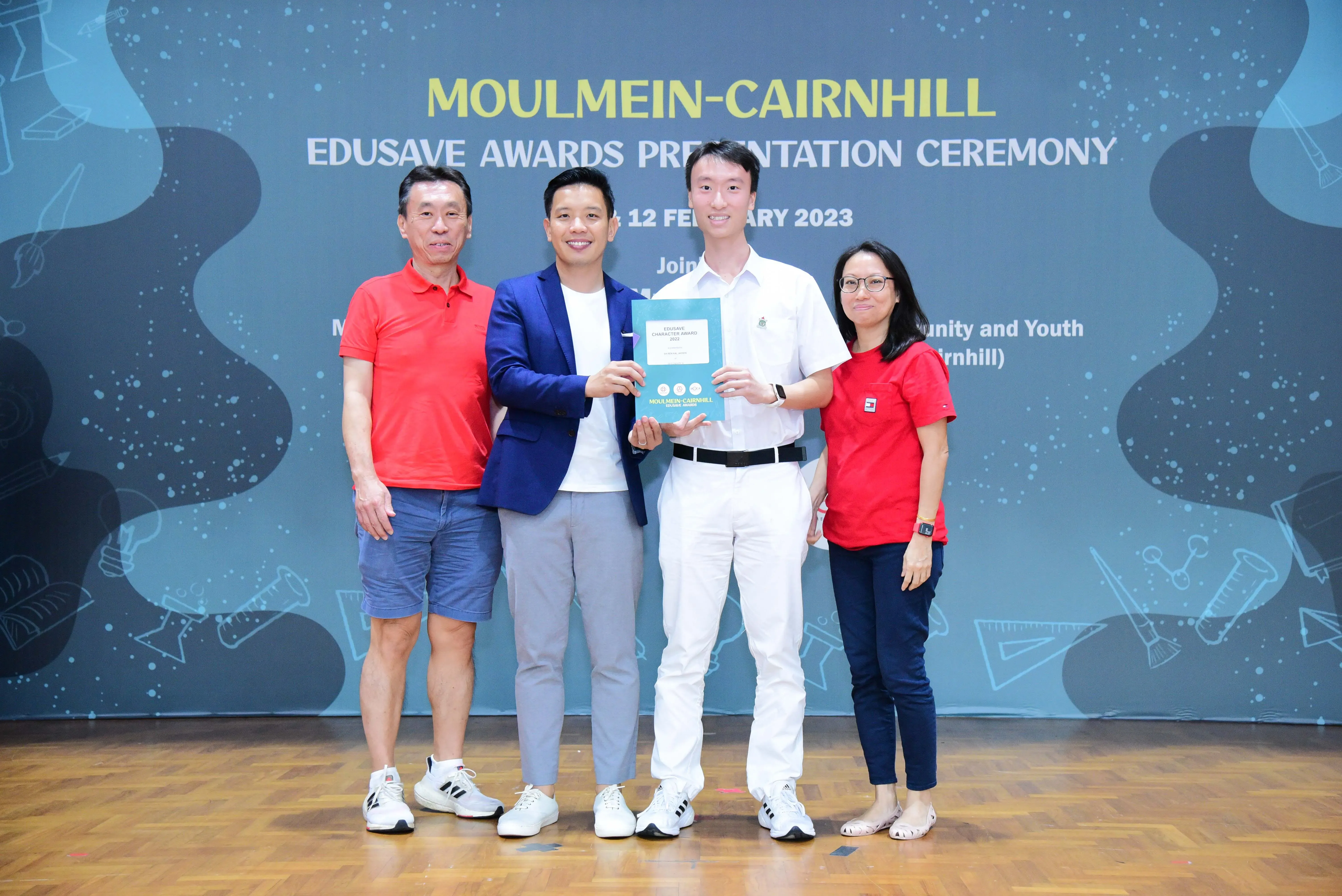 Four people pose at the Moulmein-Cairnhill Edusave Awards Presentation Ceremony on 12 February 2023.